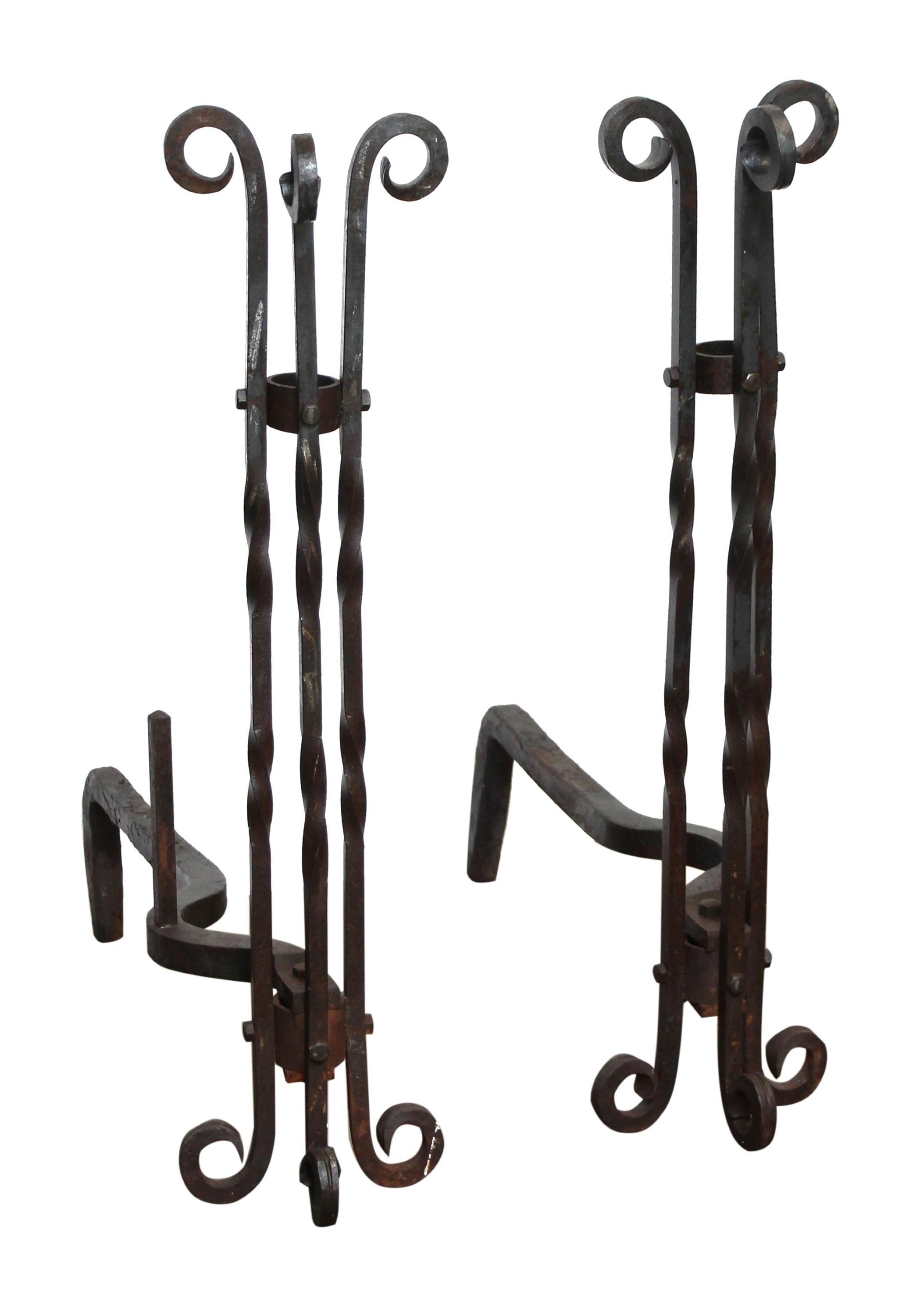 Pair of tall wrought iron andirons with twisted design and curled top and legs. These andirons have an unusual, elegant design and are tall and narrow. Priced as a pair. Measure - 28.5 in.