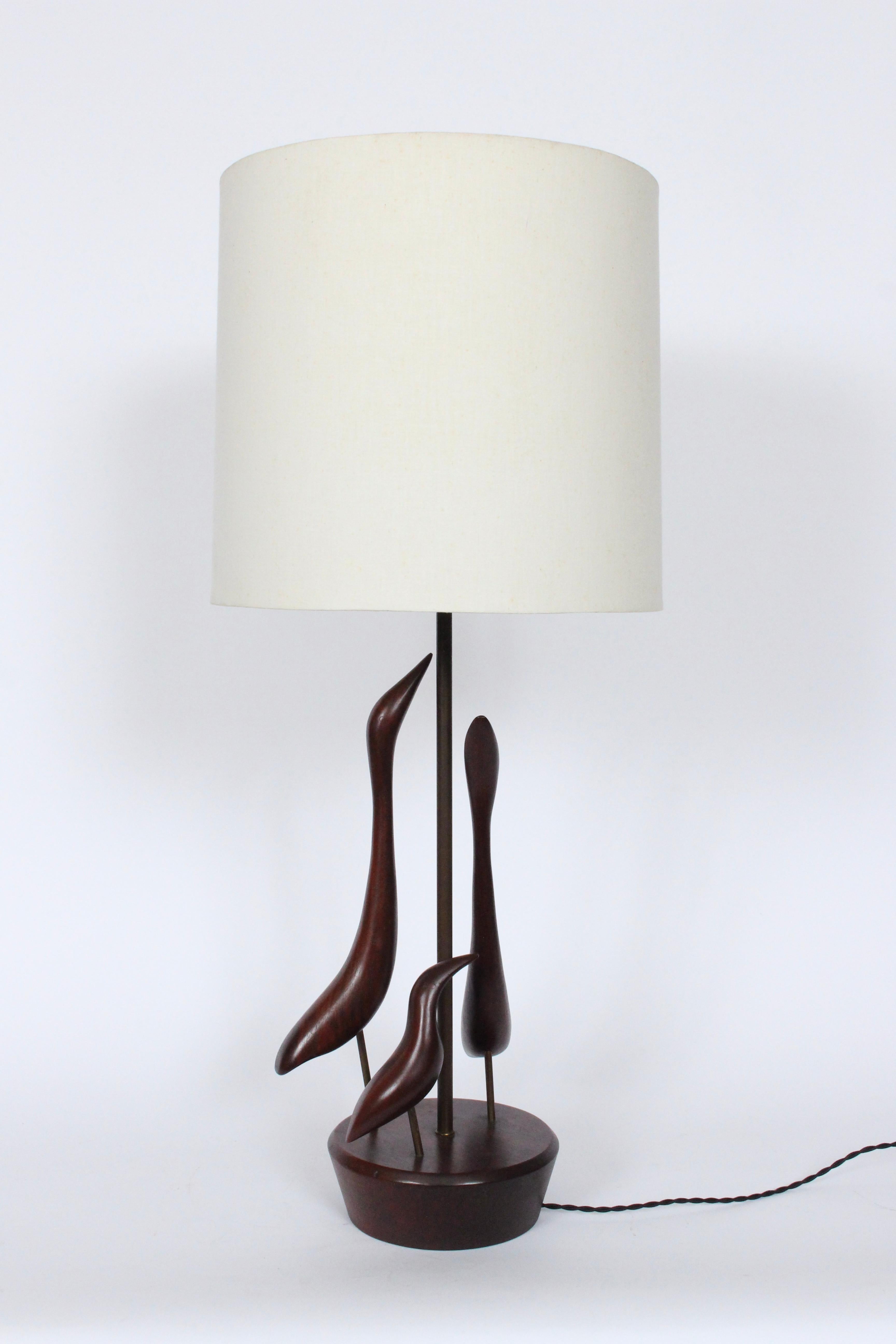 Substantial Val Robbins hand crafted abstract shore birds solid walnut table lamp. circa 1960. Featuring three hand carved dark solid walnut birds, with original finish, a top a flared round Walnut base. Small footprint. 25H to top of socket. Base