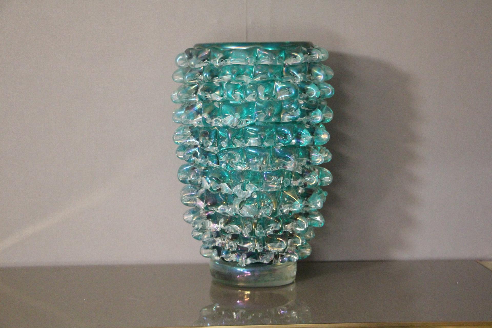 A very impressive, imposing size in clear and deep blue-green blown Murano glass, hand decorated with the technique rostrato: spikes of glass individually pulled in relief.
Thick walled casing glass produces a lot of iridescent reflects.
Signed on