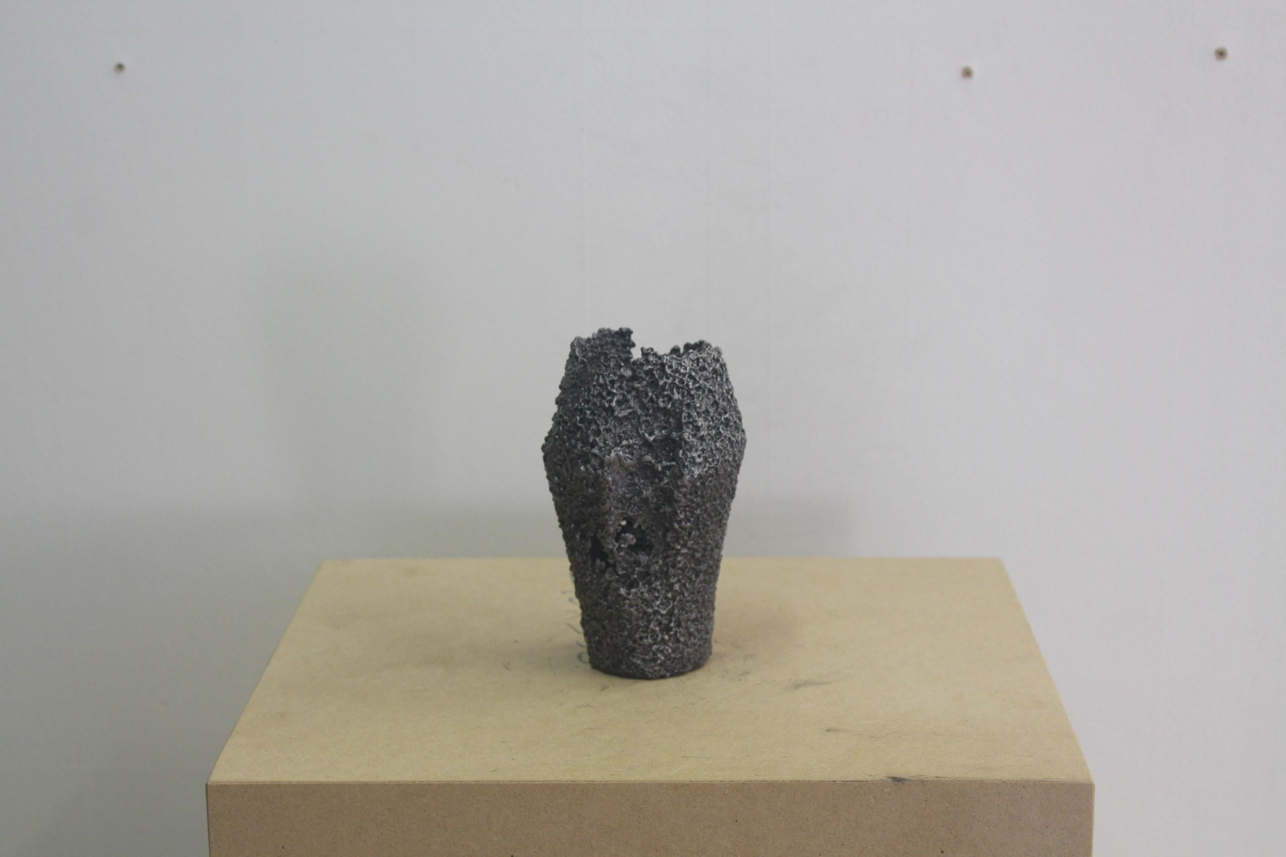 Tall Vessel Small by Saturday Yard Work
Dimensions: W 10 x D 10 x H 15 cm
Materials: Aluminium.
Finish: Blackened texture. 

SATURDAY YARD WORK by Nathan Martin is a Kaurna/Adelaide based practice that aims to find a medium between sculpture, craft,
