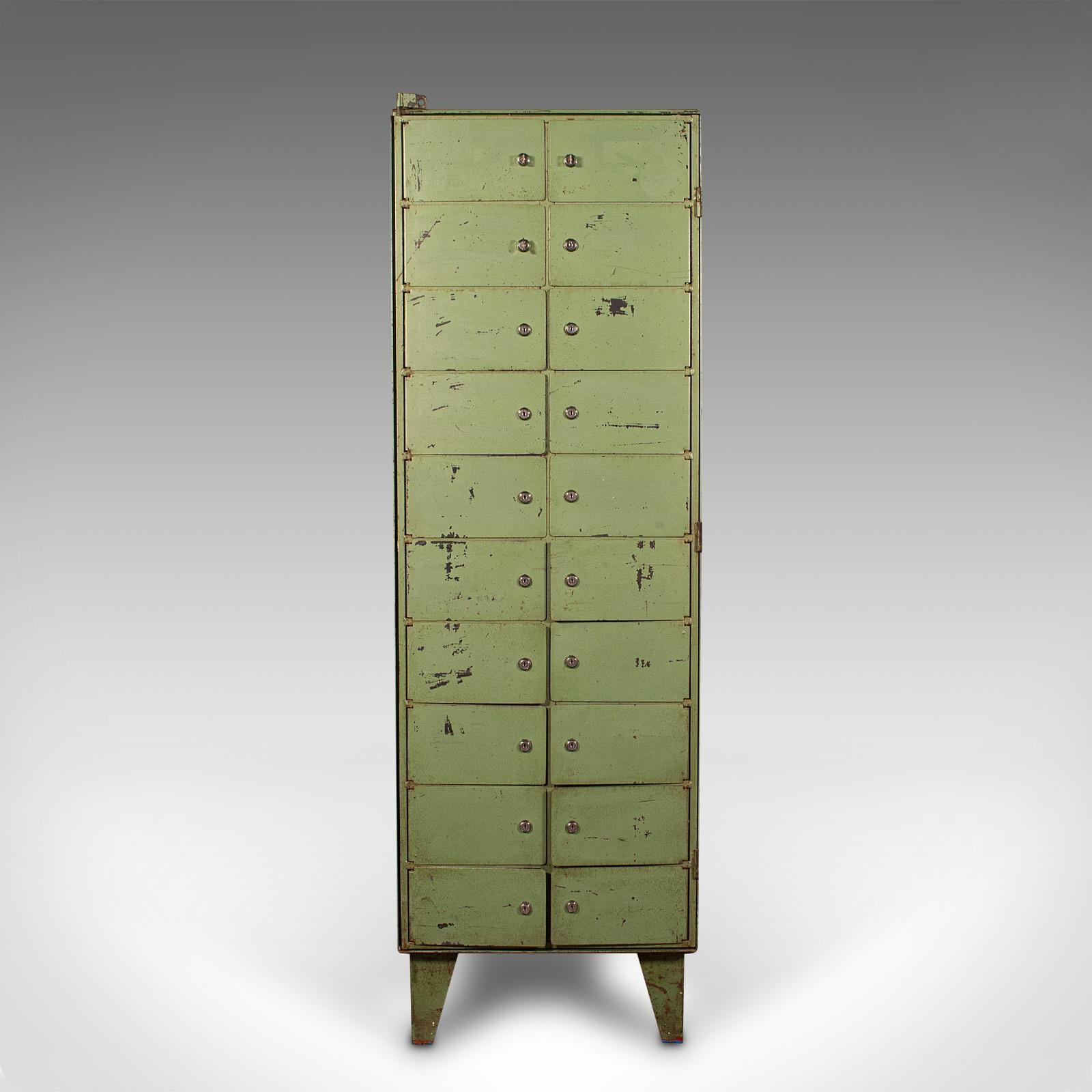 This is a tall vintage bank of pigeon holes. A German, steel 20 door slope front industrial machinist's cabinet, dating to the mid 20th century, circa 1950.

Fascinating Continental pigeon holes, with a weathered appearance
Displaying a desirable