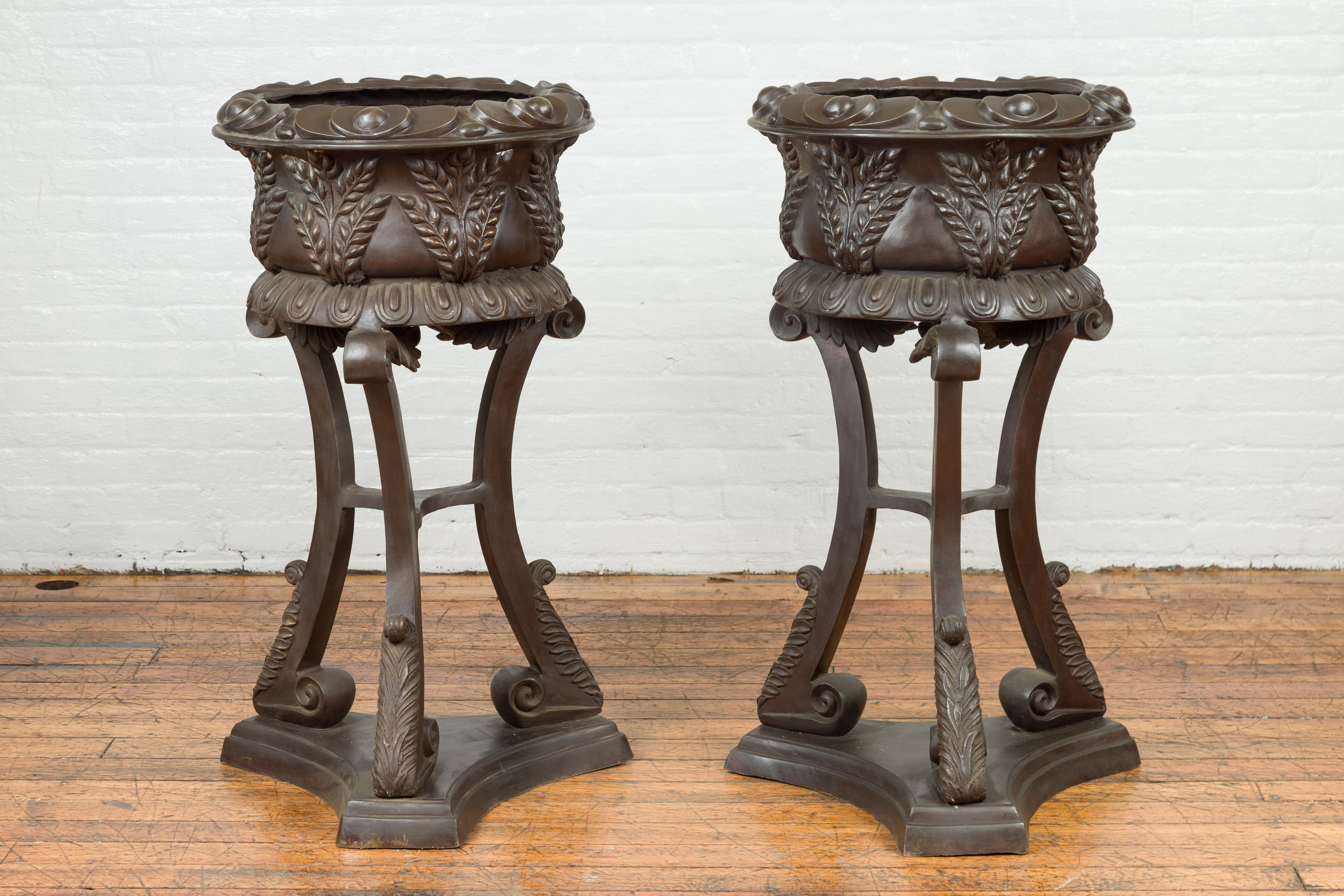 A tall vintage bronze European style tripod planter with unusual raised floral design and dark bronze patina. Each planter is priced and sold individually. Created with the traditional technique of the lost-wax (à la cire perdue) that allows a great