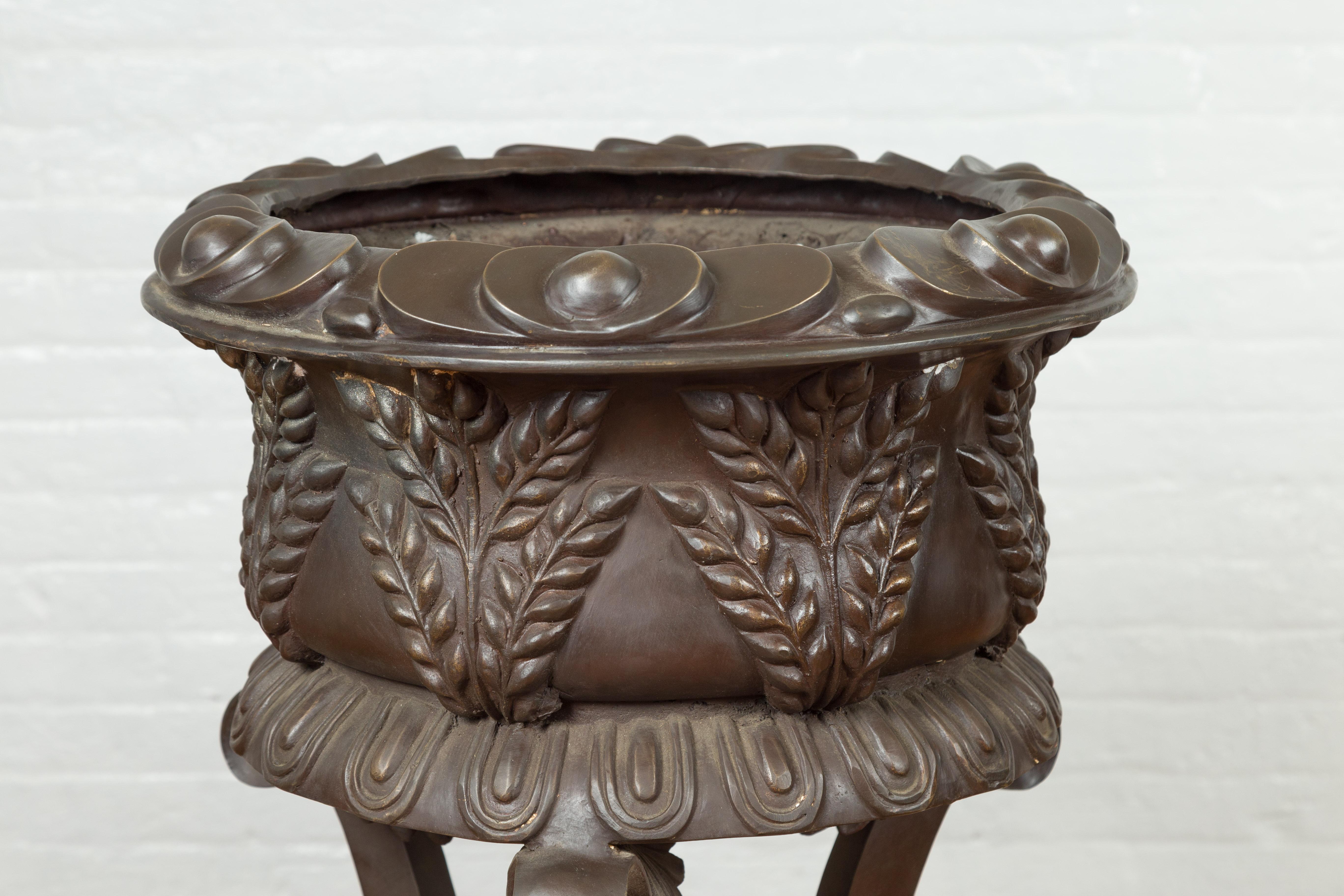 Cast Tall Vintage Bronze European Style Tripod Planter with Raised Floral Motifs For Sale