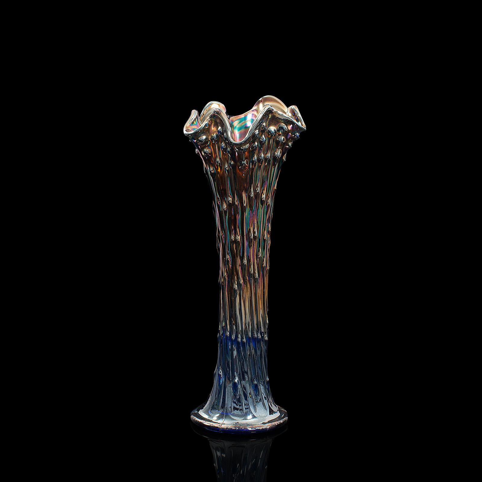 This is a tall, vintage decorative carnival vase. An English, glass flower vase with colourful midcentury appeal, circa 1950.

Radiant color accentuates the fascinating form
Displaying a desirable aged patina and in good original order
Deep blue