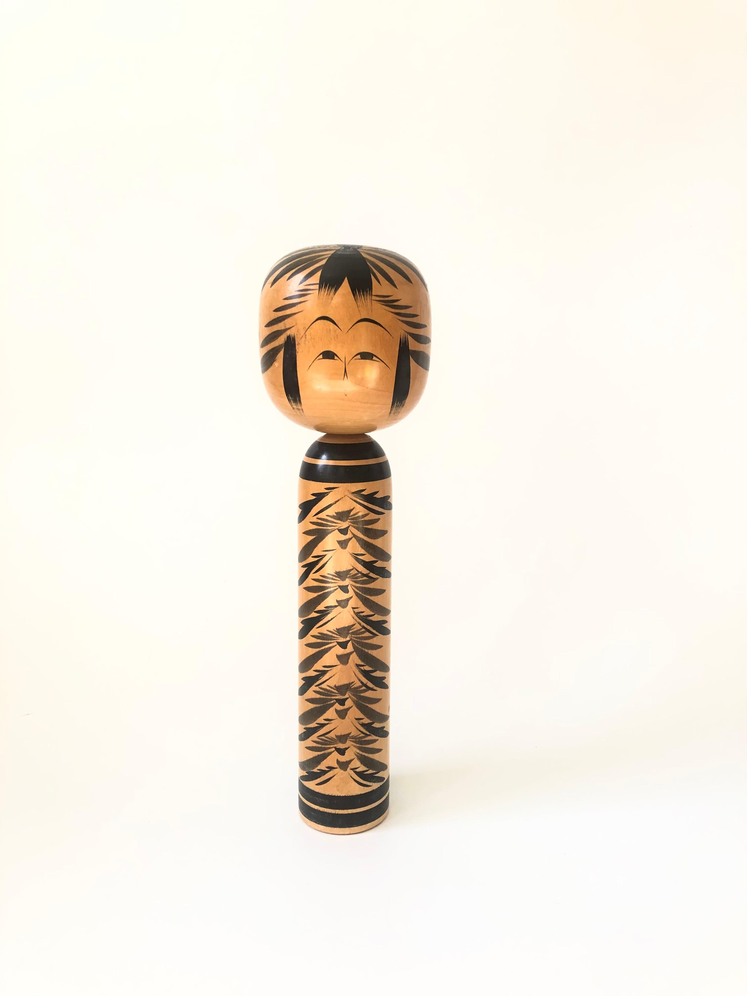A tall vintage Japanese kokeshi doll. Made of wood with a lovely hand painted design.

