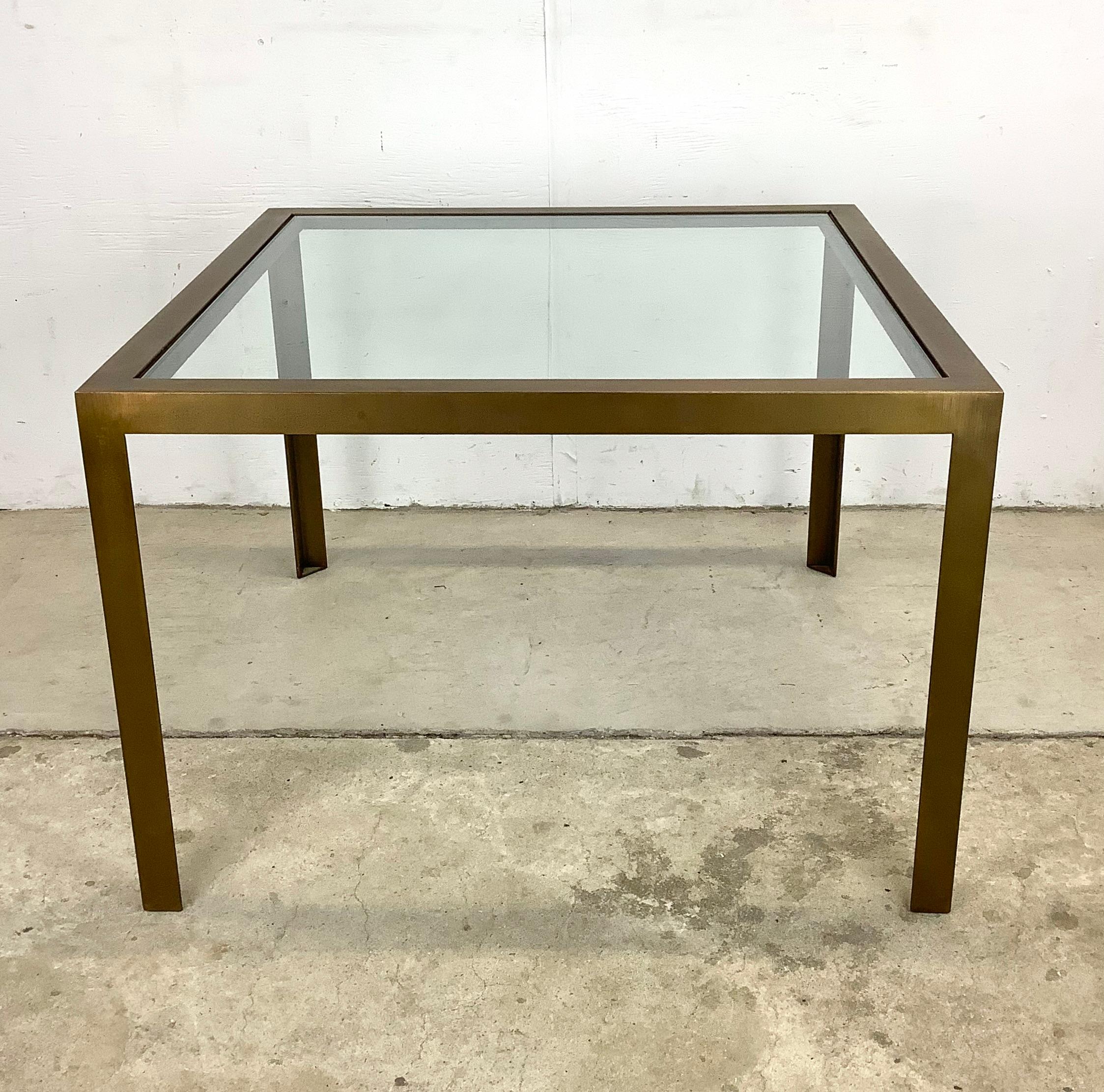 This vintage modern bronze finish glass top square coffee table makes a simple yet striking statement piece to any seating arrangement. Clean modern lines, mid-century style, and substantial manufacture make this the perfect mcm centerpiece for any