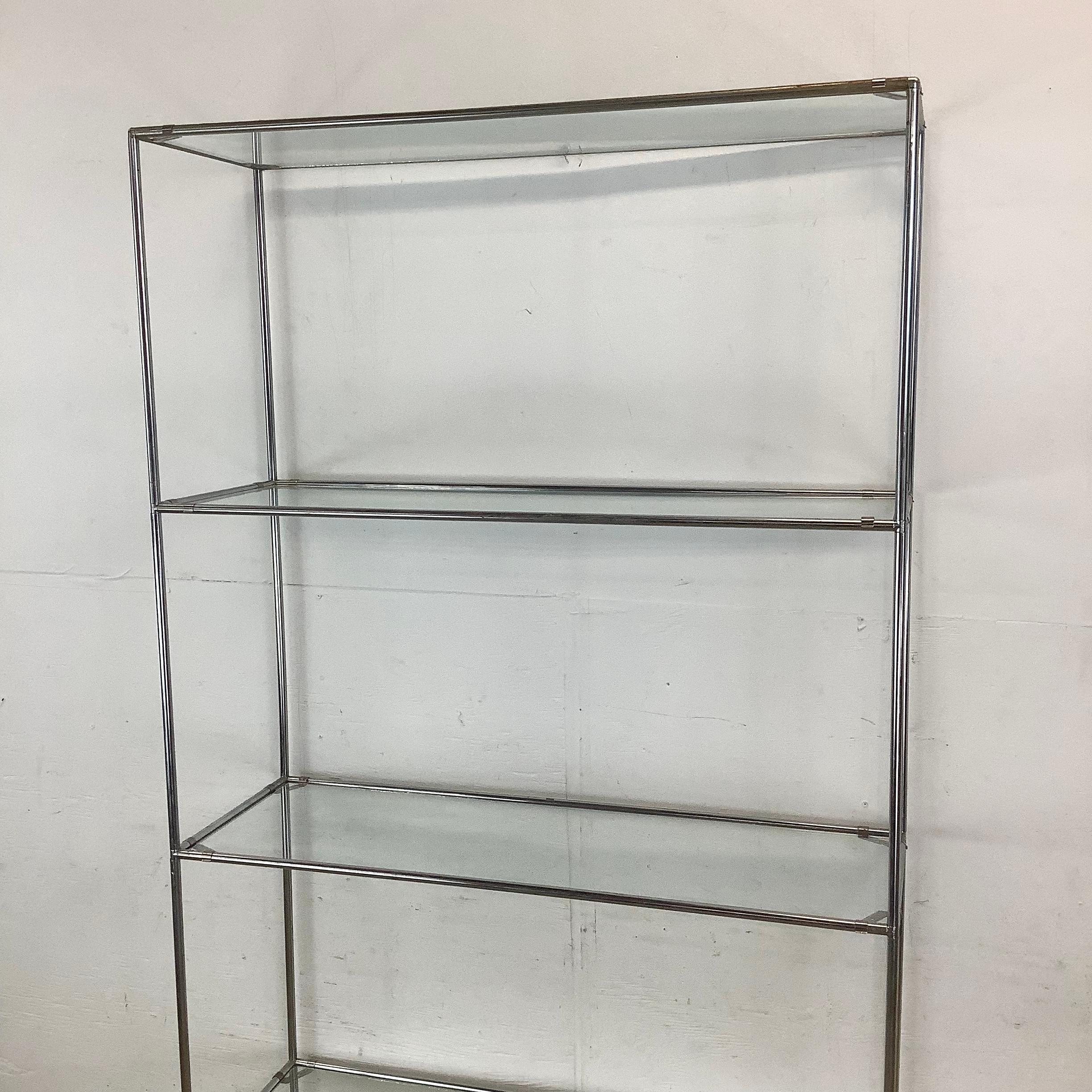 This vintage chrome étagère is a striking example of modernist design, built with a tall modular frame that commands presence. Its reflective chrome finish introduces light and sparkle into a room, giving it an architectural quality that enhances