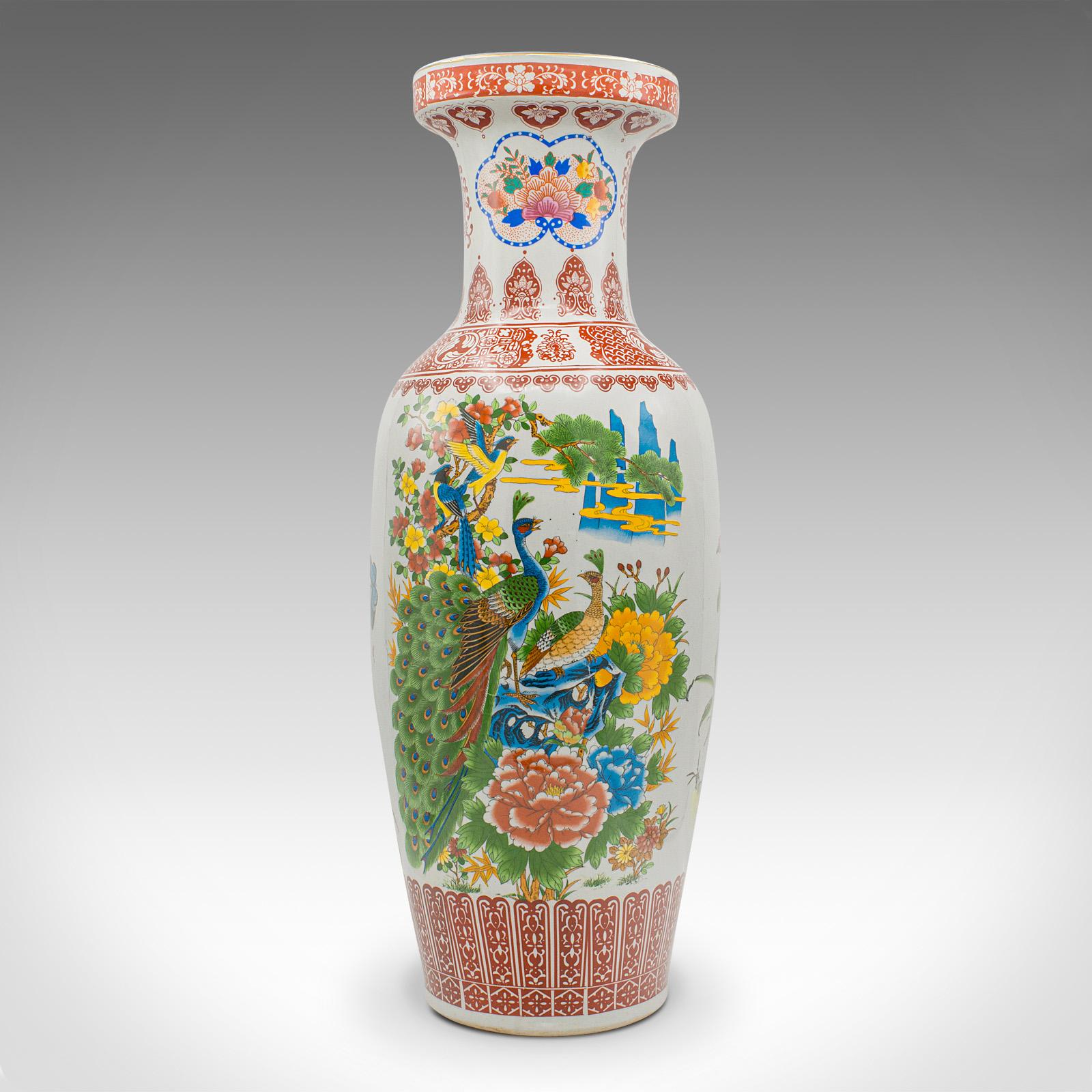 This is a tall vintage peacock vase. A Chinese, ceramic baluster urn with late Art deco taste, dating to the mid 20th century, circa 1950.

Charmingly colourful, with generous proportion and form
Displays a desirable aged patina and in good