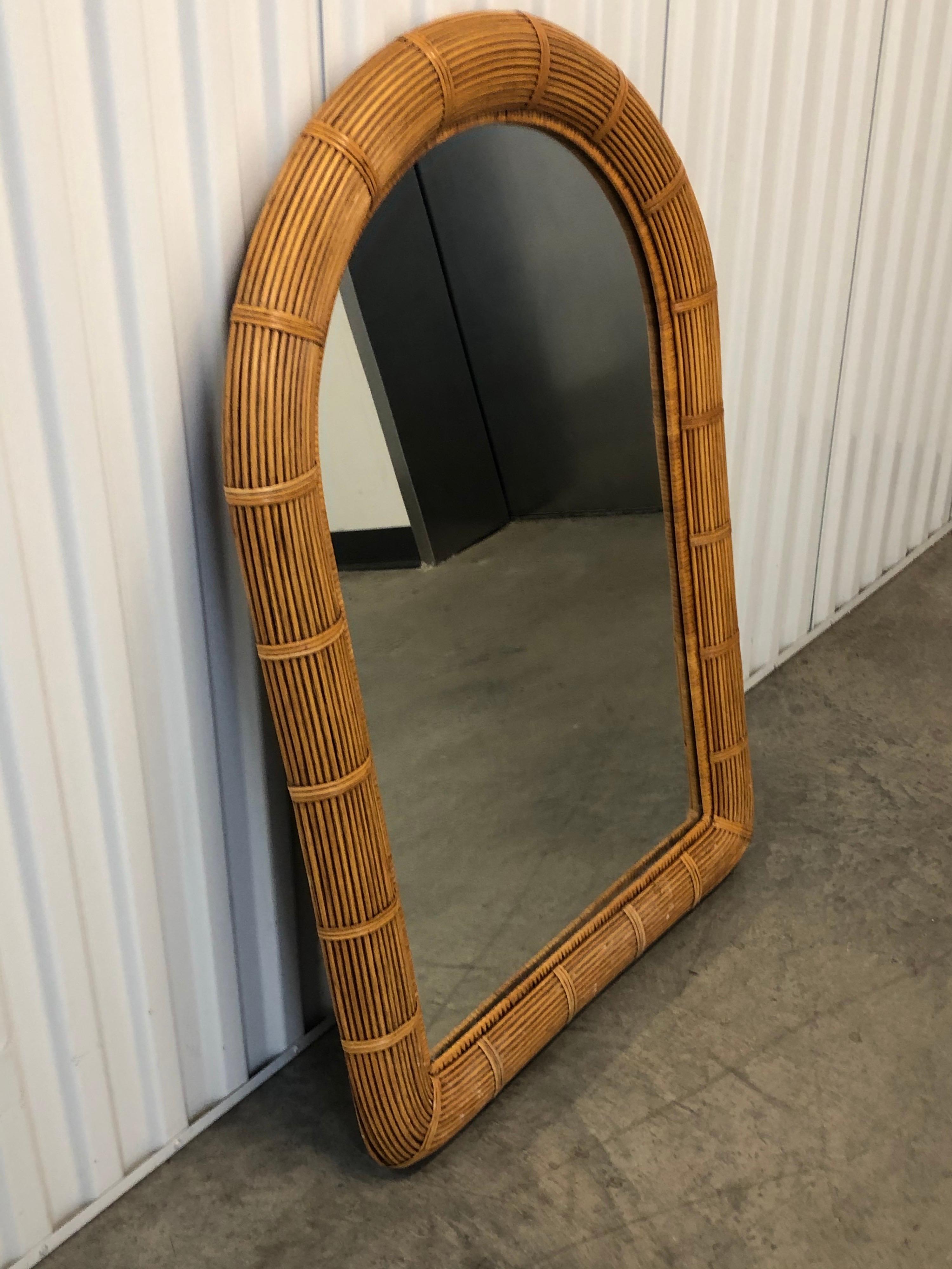Tall vintage reeded wicker wall mirror with original plywood backing.
Oval top and rounded top frame. Hanging hooks in the back.
Size: 41.5