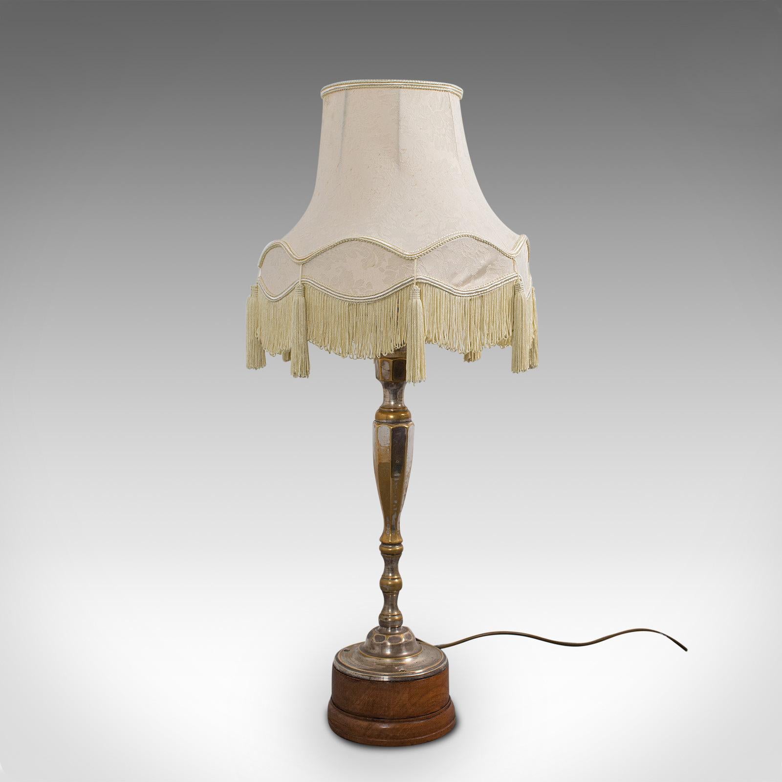 This is a tall vintage table lamp. An English, walnut and silver-plated side or occasional light, dating to the early 20th century, circa 1930.

Add a dash of practical elegance to the corner of the room
Displaying a desirable aged patina -