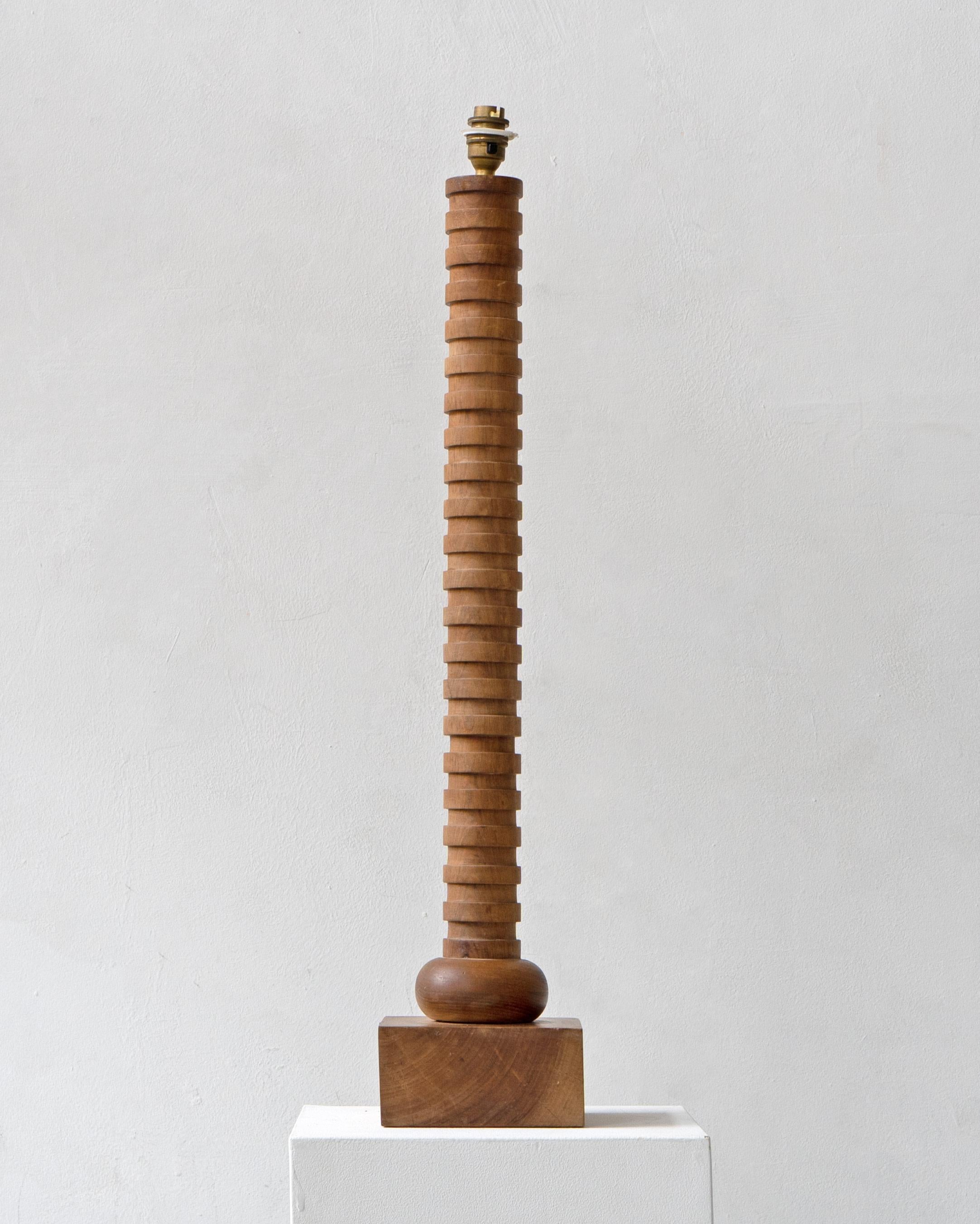  tall vintage turned wood table lamp. 

Dimensions (cm, approx):
Height: 77
Width: 15
Depth: 15

In full working order and good vintage condition.
