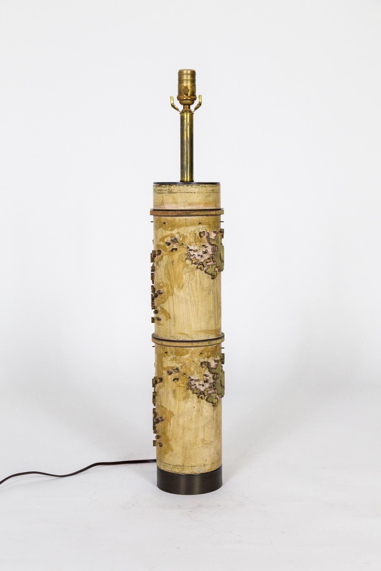 A lamp made from a vintage roller for printing wallpaper. uniquely detailed flower designs with interesting markings from the printing process. Newly made into a table lamp with complimentary patinated brass hardware and dimmer on the socket.