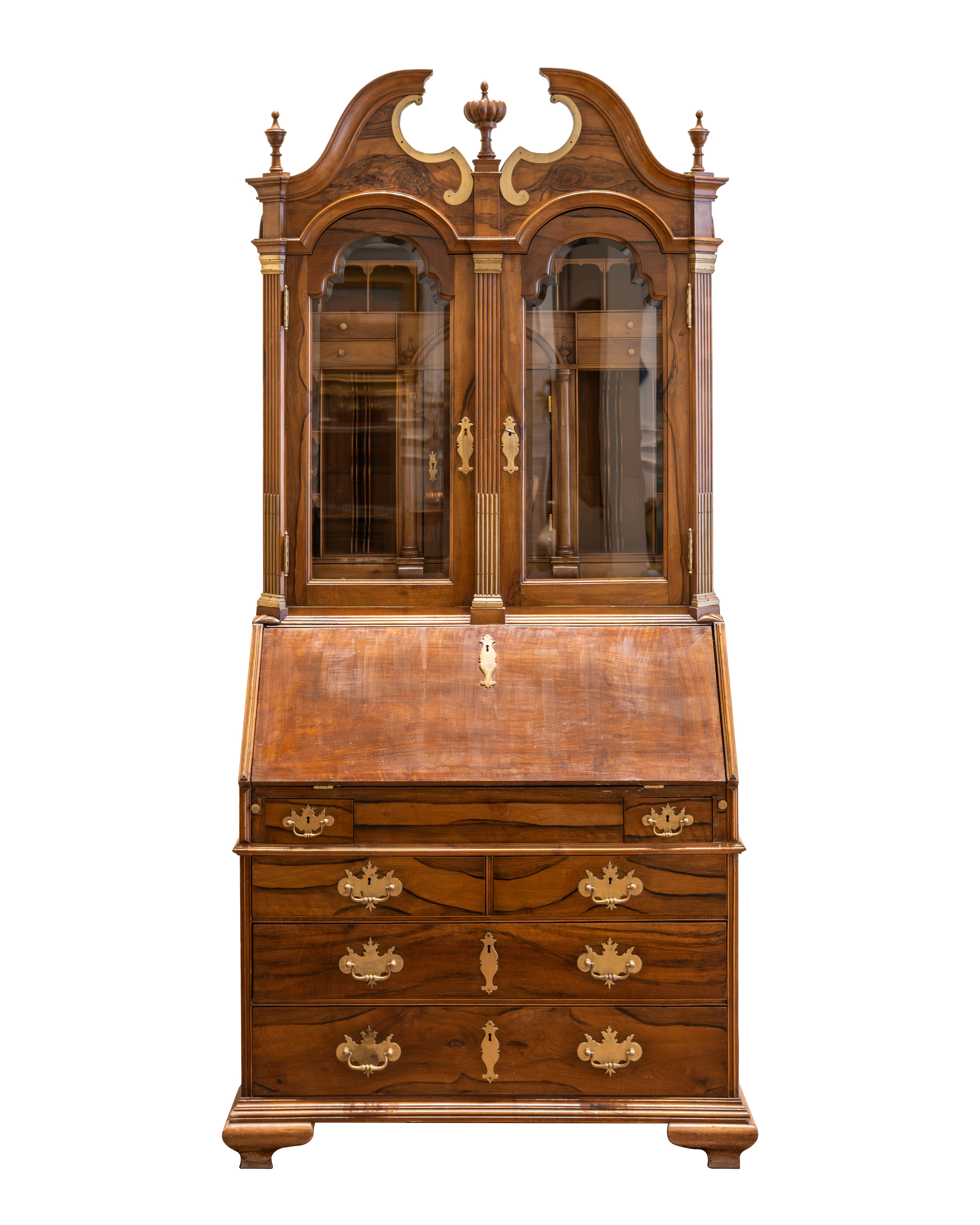 Tall walnut desk cabinet in Baroque style with gilded brass ornamentation. The upper glazed part reveals seven drawers, a leaf, and fifteen lockers, the flap revealing six drawers, six lockers, and a leaf, the chest of drawers with six drawers.