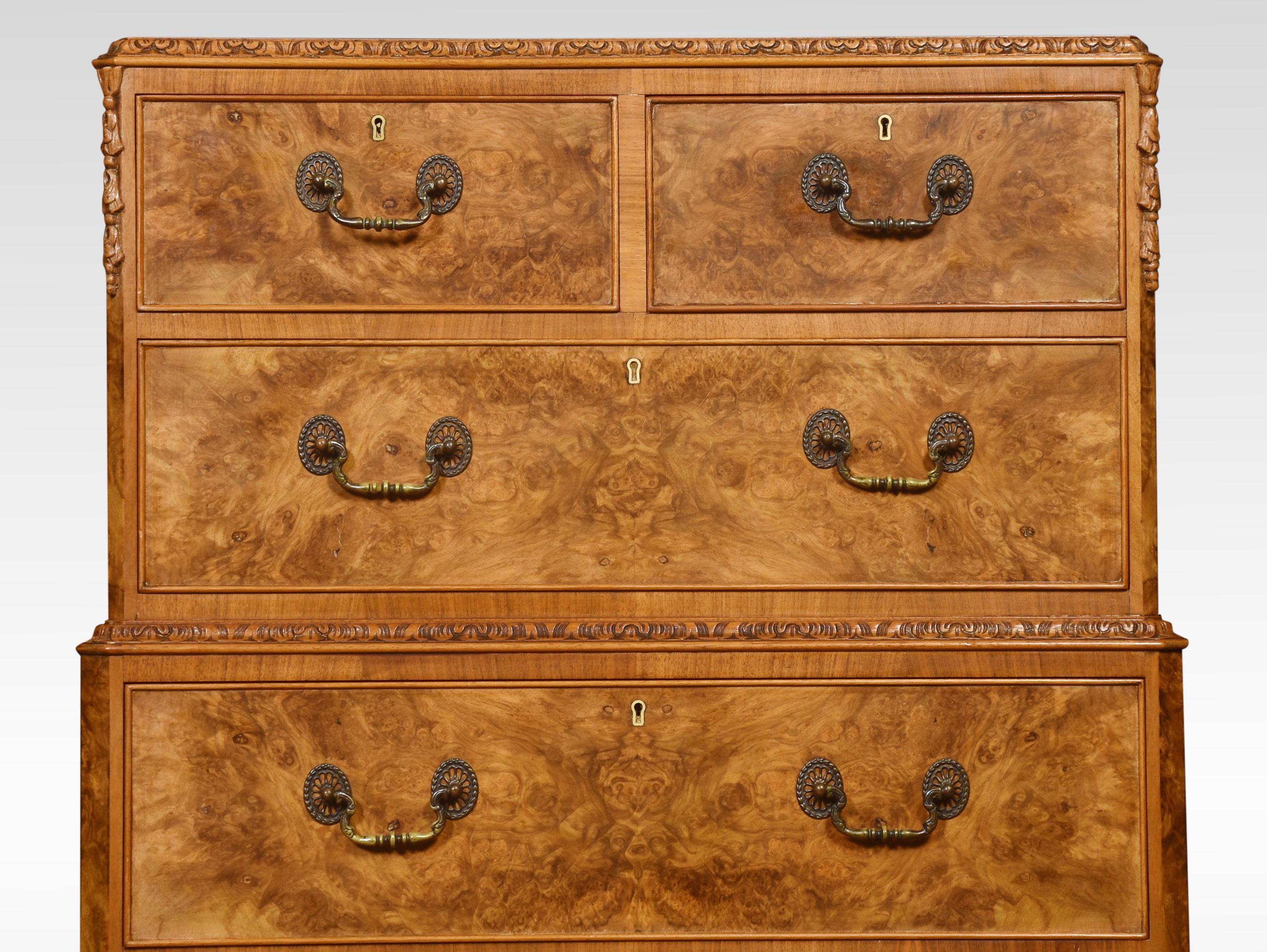 Walnut chest of drawers, the rectangular top with carved moulded edge above two short and one long drawer, to the base section fitted with a further four long graduated drawers with tooled handles. All raised up on a shaped plinth and short cabriole