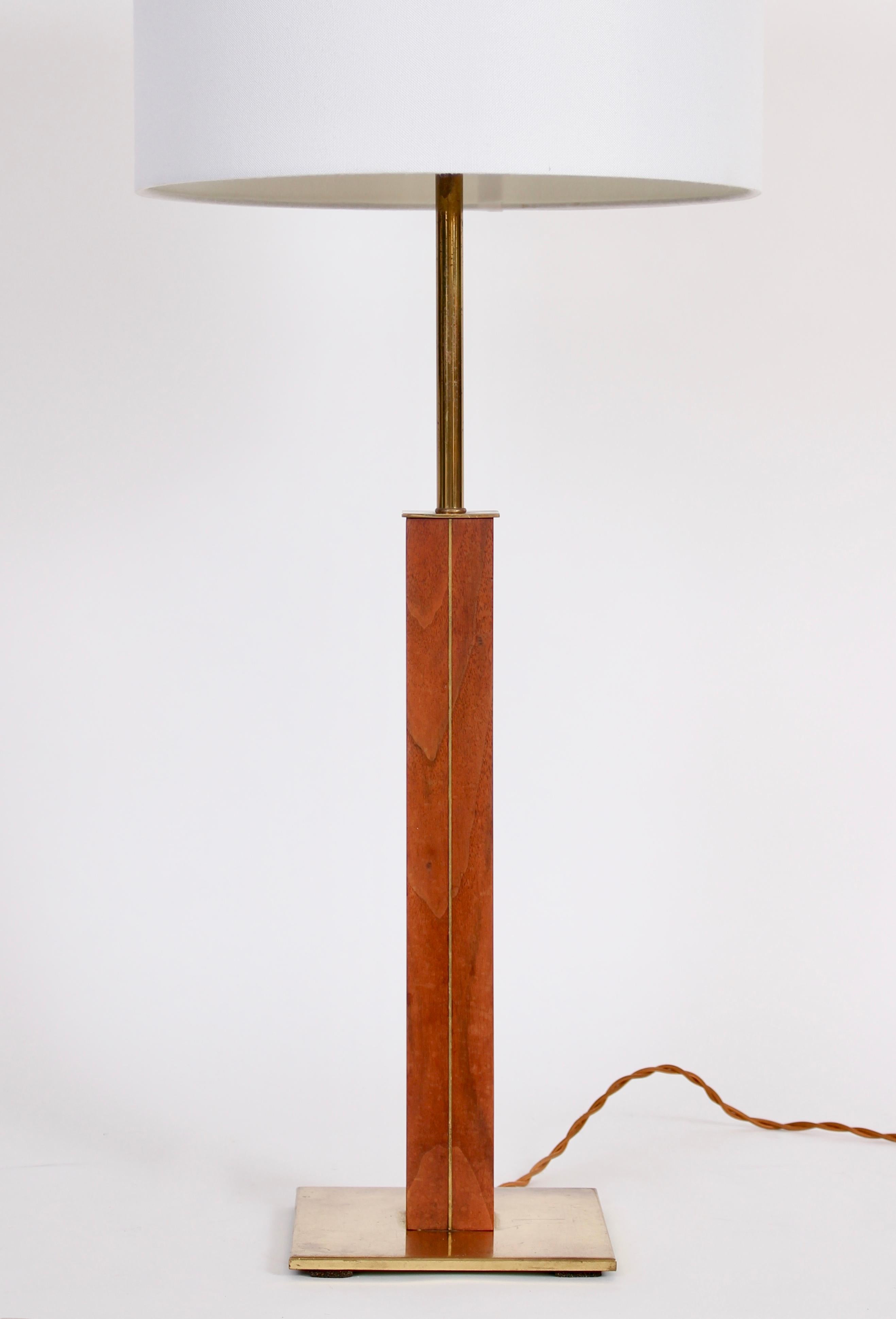 Towering Walter Von Nessen designed Nessen Studios Walnut & Brass Table Lamp, 1960s. Featuring an architectural solid hardwood column with vertical brass inlay. Small footprint. Adjustable double sockets. Shade shown for display only and not for