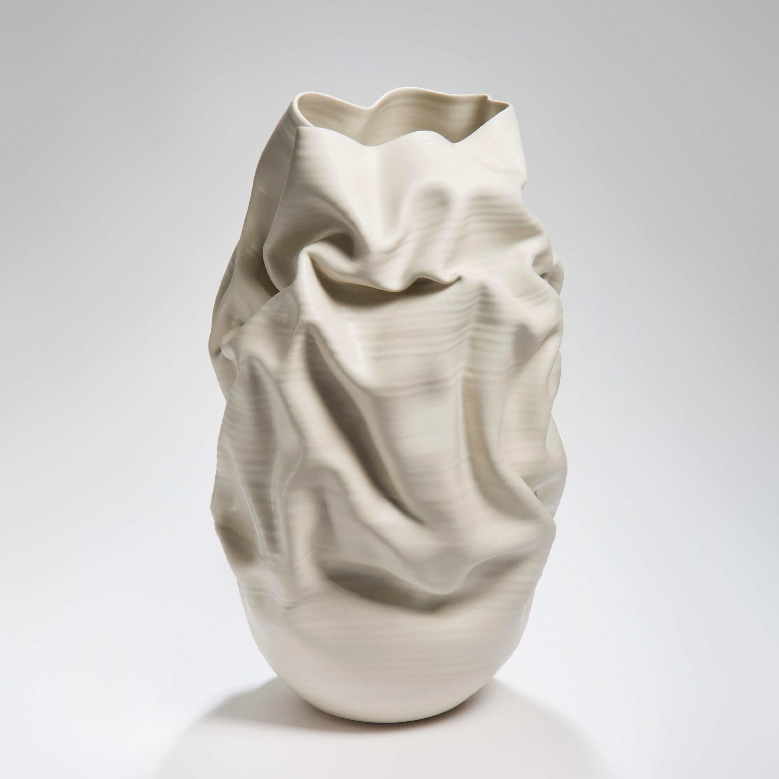 Tall white crumpled form No 31 is a unique ceramic sculptural vessel by the British artist Nicholas Arroyave-Portela.

Nicholas Arroyave-Portela’s professional ceramic practice began in 1994. After 20 years based in London, he moved and set up his