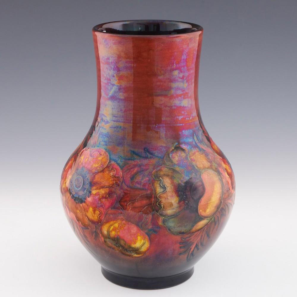 Tall William Moorcroft Anemone Flambe Vase, circa 1935

Additional Information:
Date: circa 1935
Origin: Burslem, England
Bowl Features: Depicts a band of anemones agains ta flambe red ground
Marks: Signed WM to base along with a stamped W