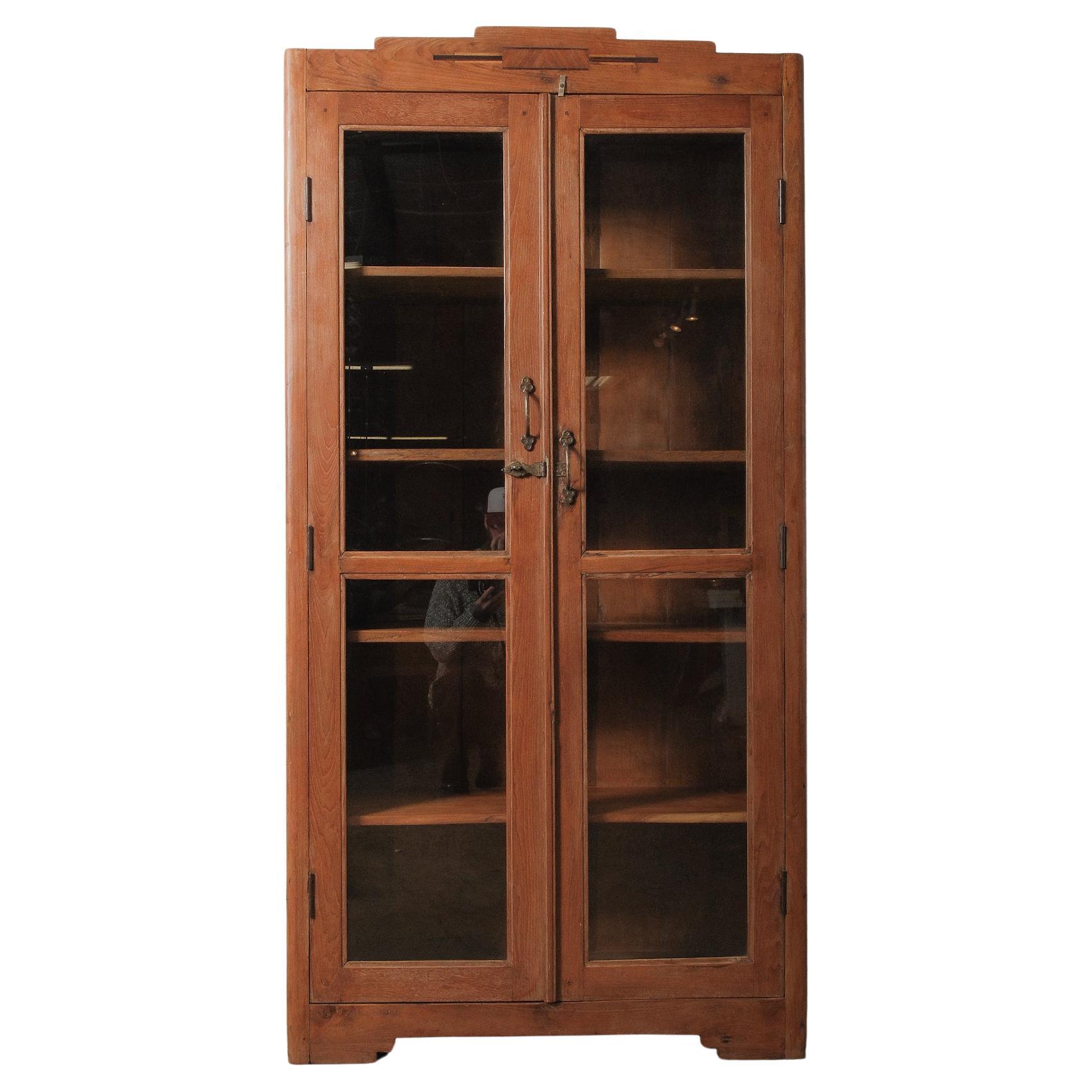 Tall Wooden Glass-Front Display Cabinet with Paneled Sides and Brass Hardware