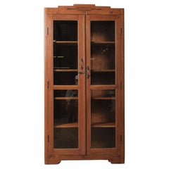 Tall Wooden Glass-Front Display Cabinet with Paneled Sides and Brass Hardware