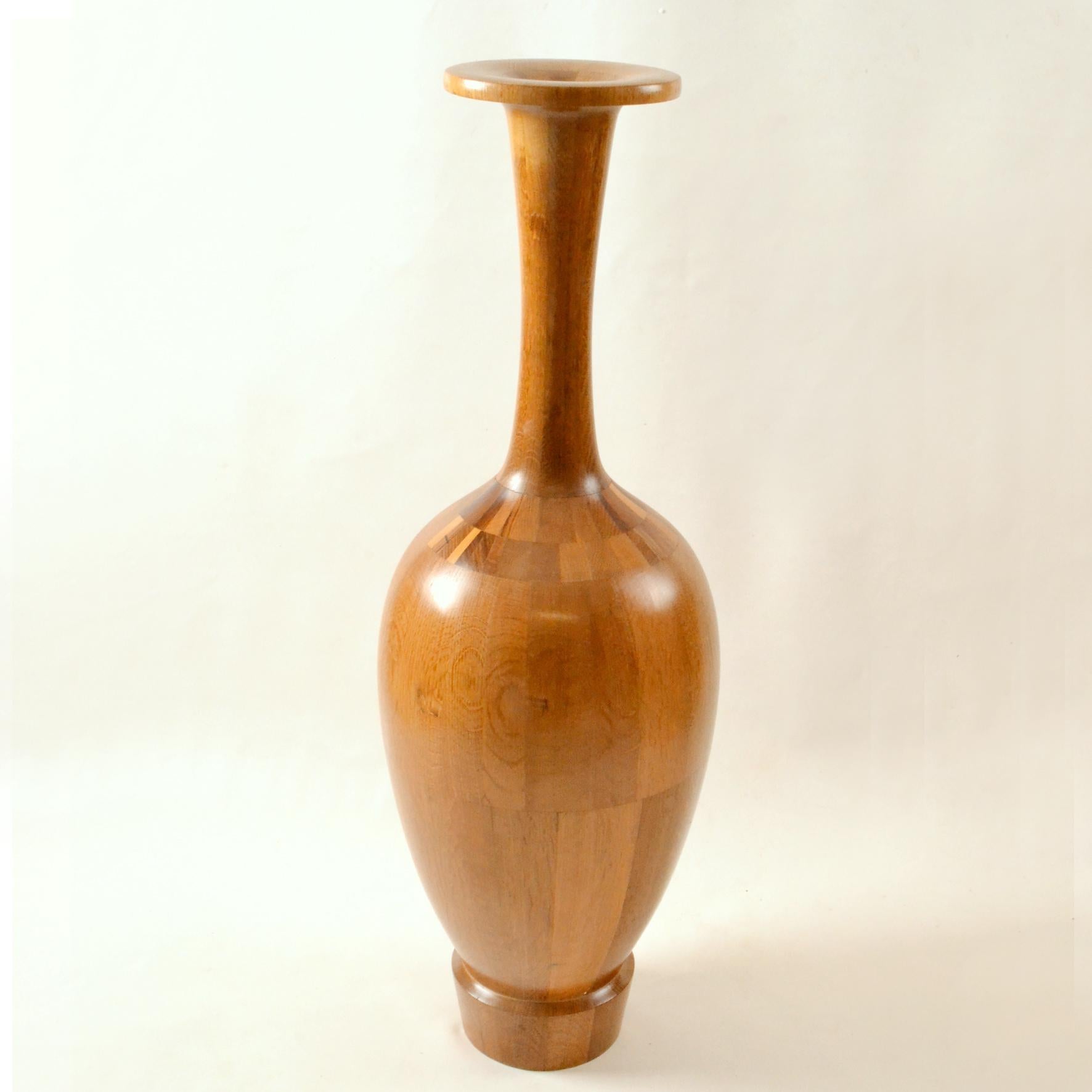 Tall hand turned wooden specimen vase by master craftsman Maurice Bonami (1929), Belgium. Intricately constructed from many different specimens of wood and turned on a lathe, produced between 1965 and 1975.
Commonly mis-attributed to Frere De Coene.
