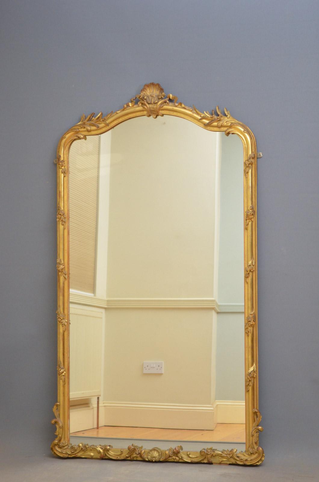 Sn4624 superb French wall or floor mirror, having original glass with some foxing and imperfection in stunning frame with floral motifs and shell crest to centre. This antique mirror retains original glass, gilt and panelled backboard, all in home