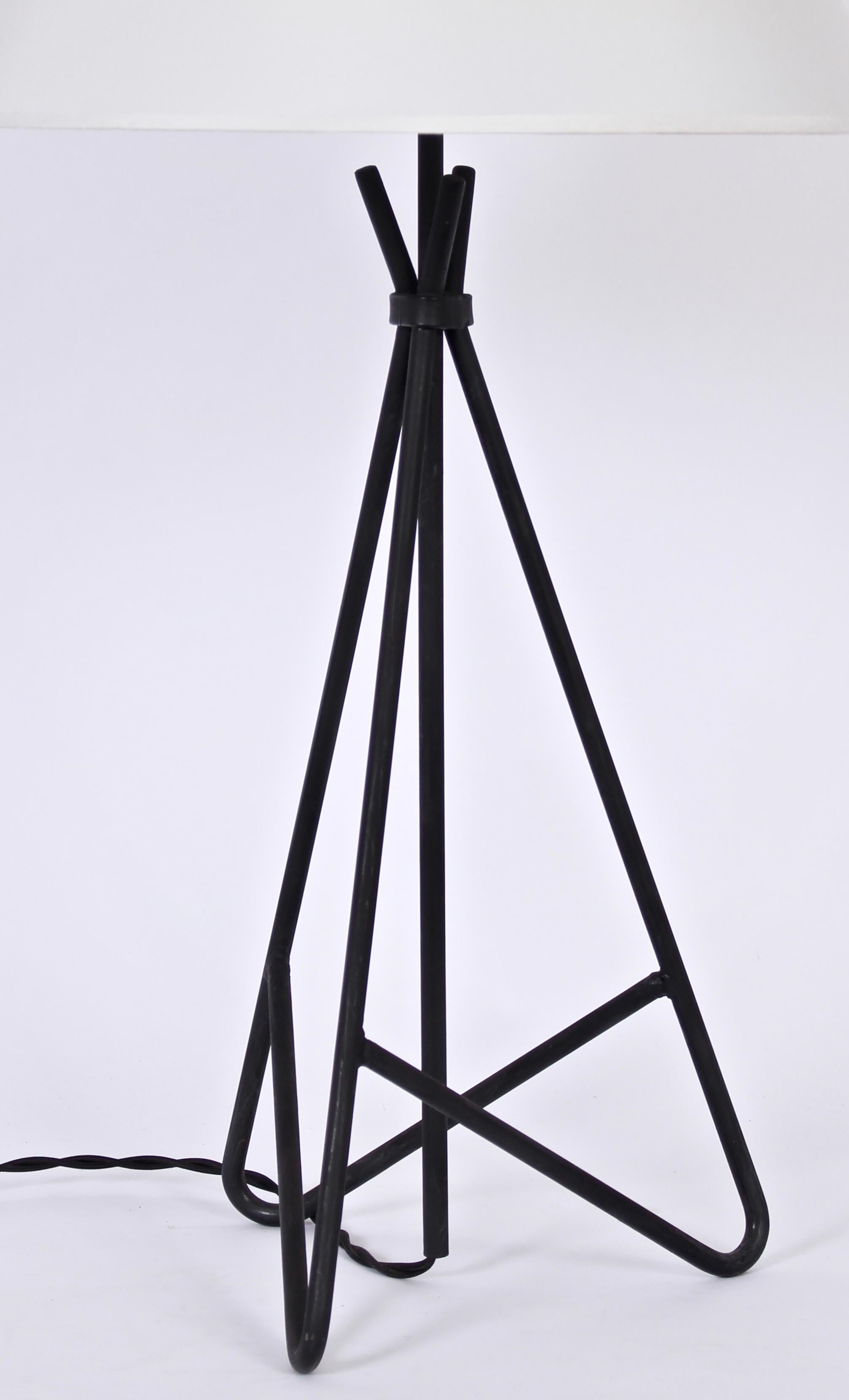 Tall pair of Weinberg Style Black Wrought Iron Triangular Form Table Lamps. Featuring an open, architectural welded, clasped, angled and balanced enameled Iron rod framework.  Clasped below socket. 22 H to top of socket. Iron 19 H. Shade shown for