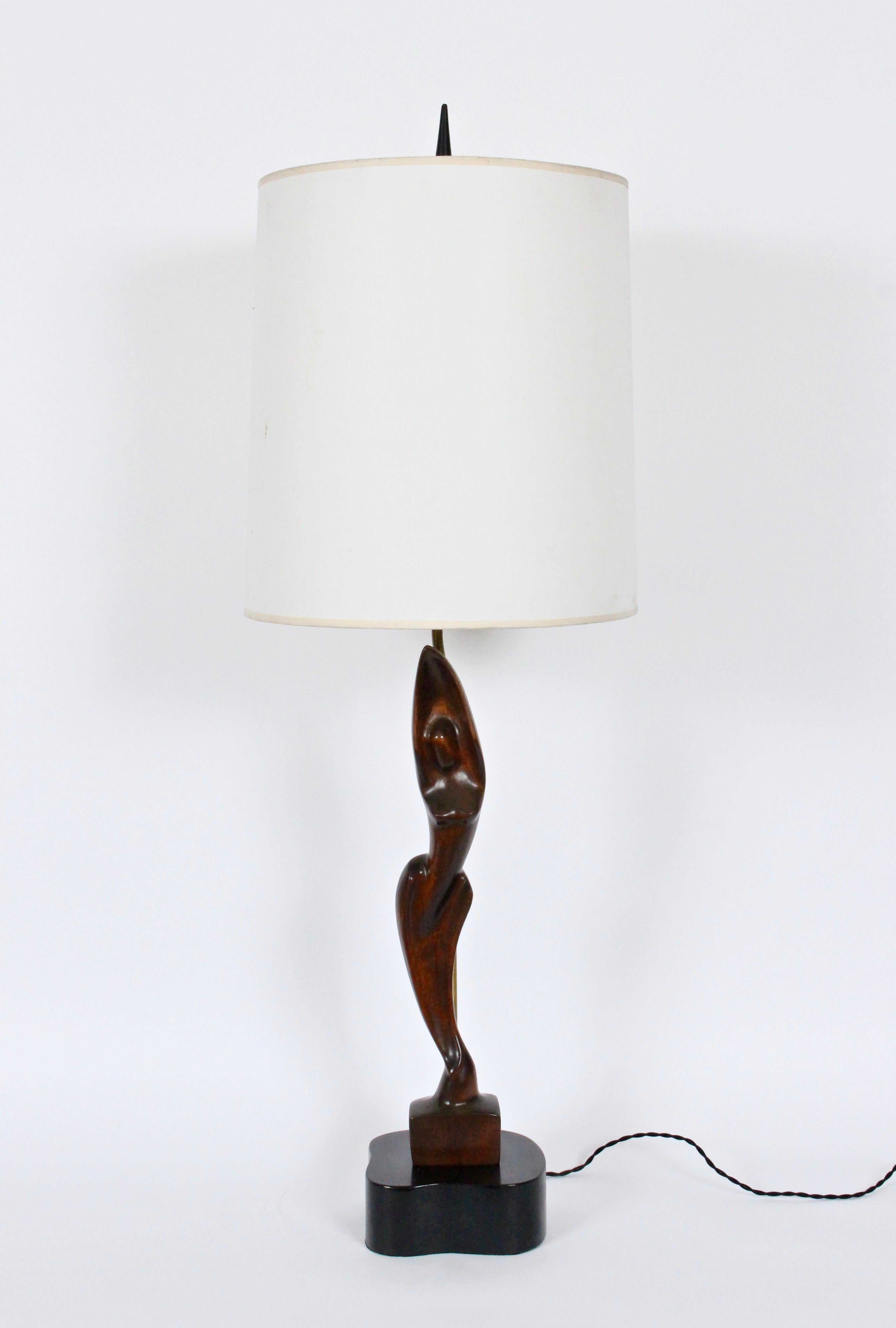 Monumental Yasha Heifetz hand-carved mahogany female form table lamp. Handcrafted slim, smooth mahogany figure mounted on free-form black enameled wooden base. Small footprint. 30H to top of socket. 24H to top of figure. Shade shown for display only