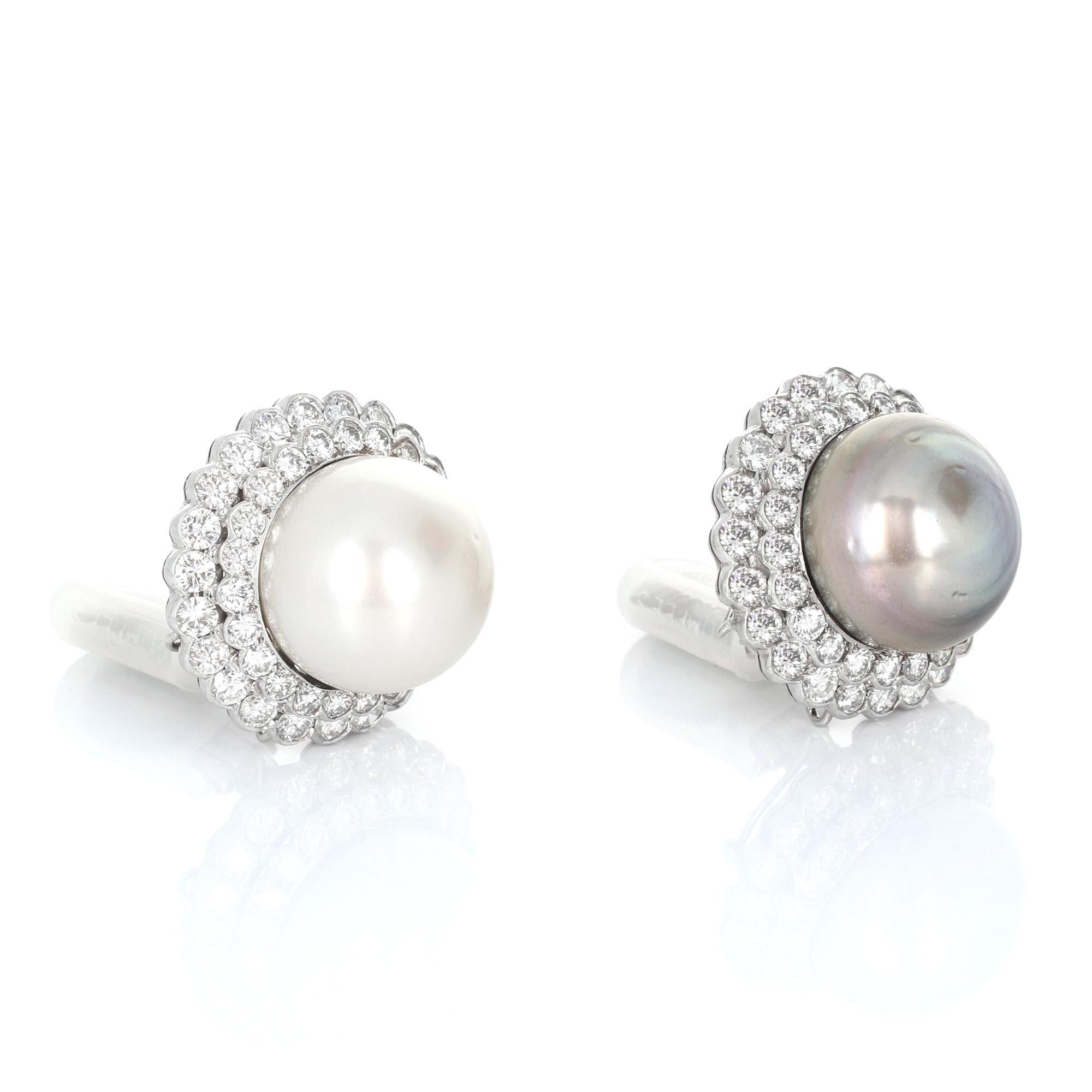 Pair of white gold south sea pearl and diamond ear clips, signed Tallarico. Made in 18 karat white gold, with round brilliant cut diamonds (F-G color, VS clarity), a white south sea pearl (measuring 17.6mm), and a black south sea pearl (measuring
