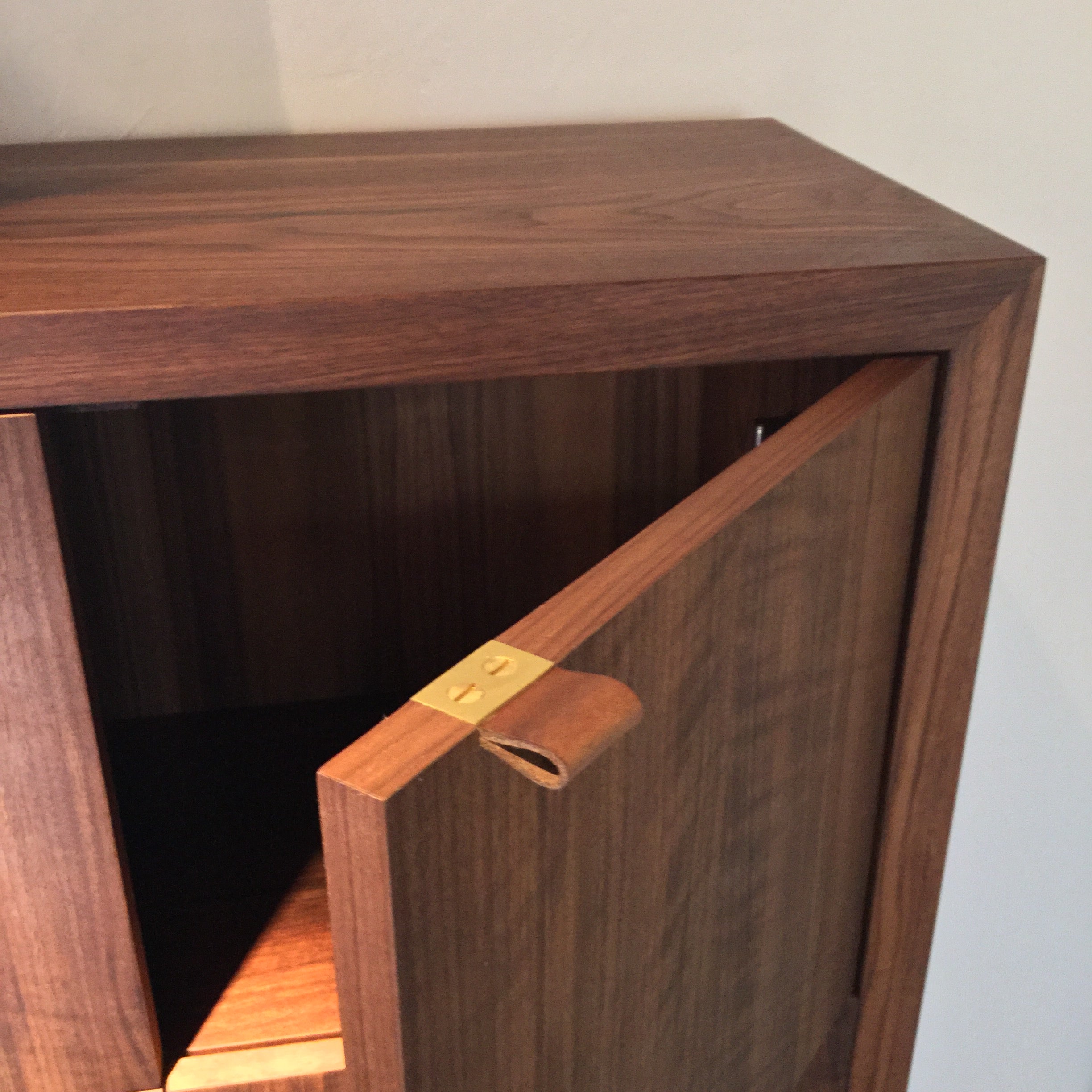 This tallboy dresser with figured claro walnut was originally designed for one of our early studio patrons who owned a historic Santa Fe home. Historic homes in this city are notorious for having no closet space and having small bedrooms. Those two