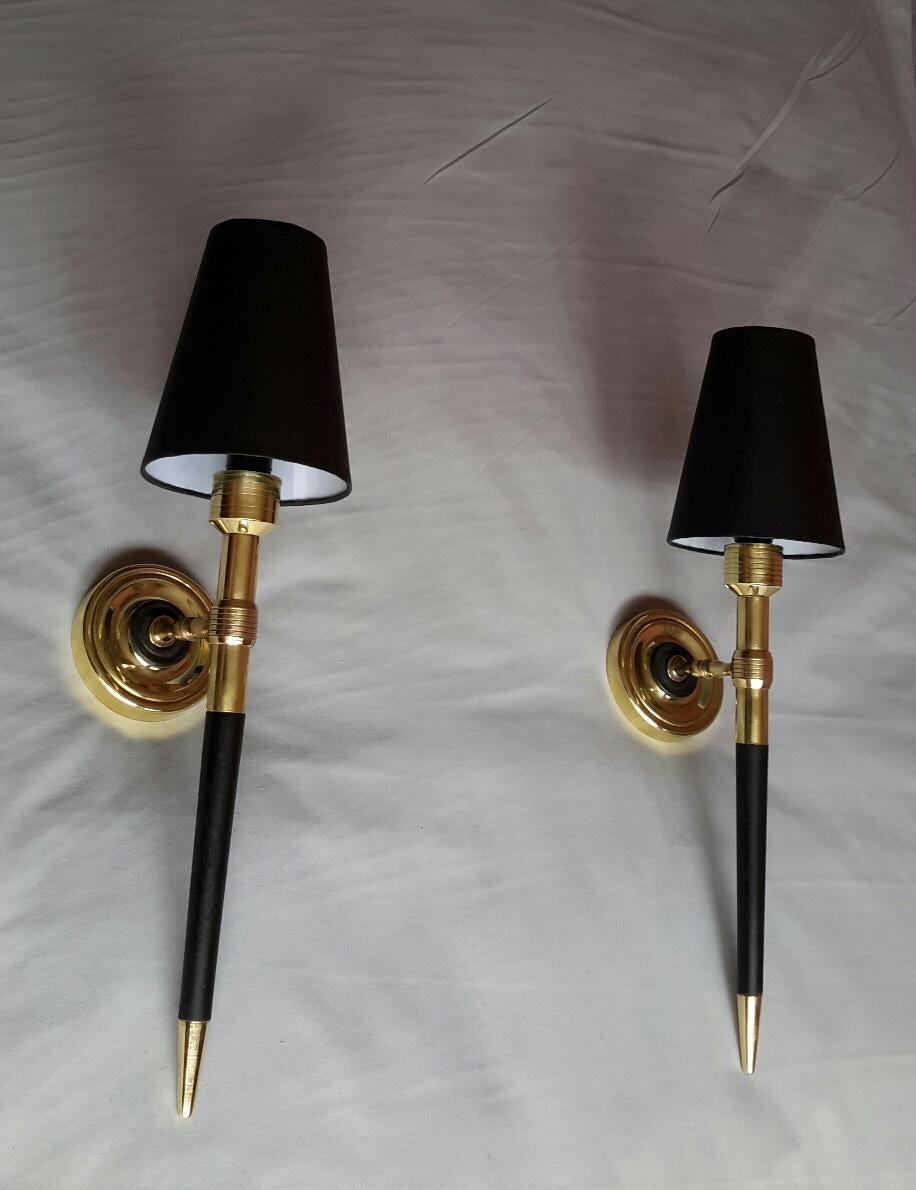 Very elegant pair of French torchère sconces in gilded bronze, black painted wood and metal from the 1960s by Maison Lancel.
The electrical system has been renewed and comply with the US standard. The black cardboard lampshade are new.
The sconces