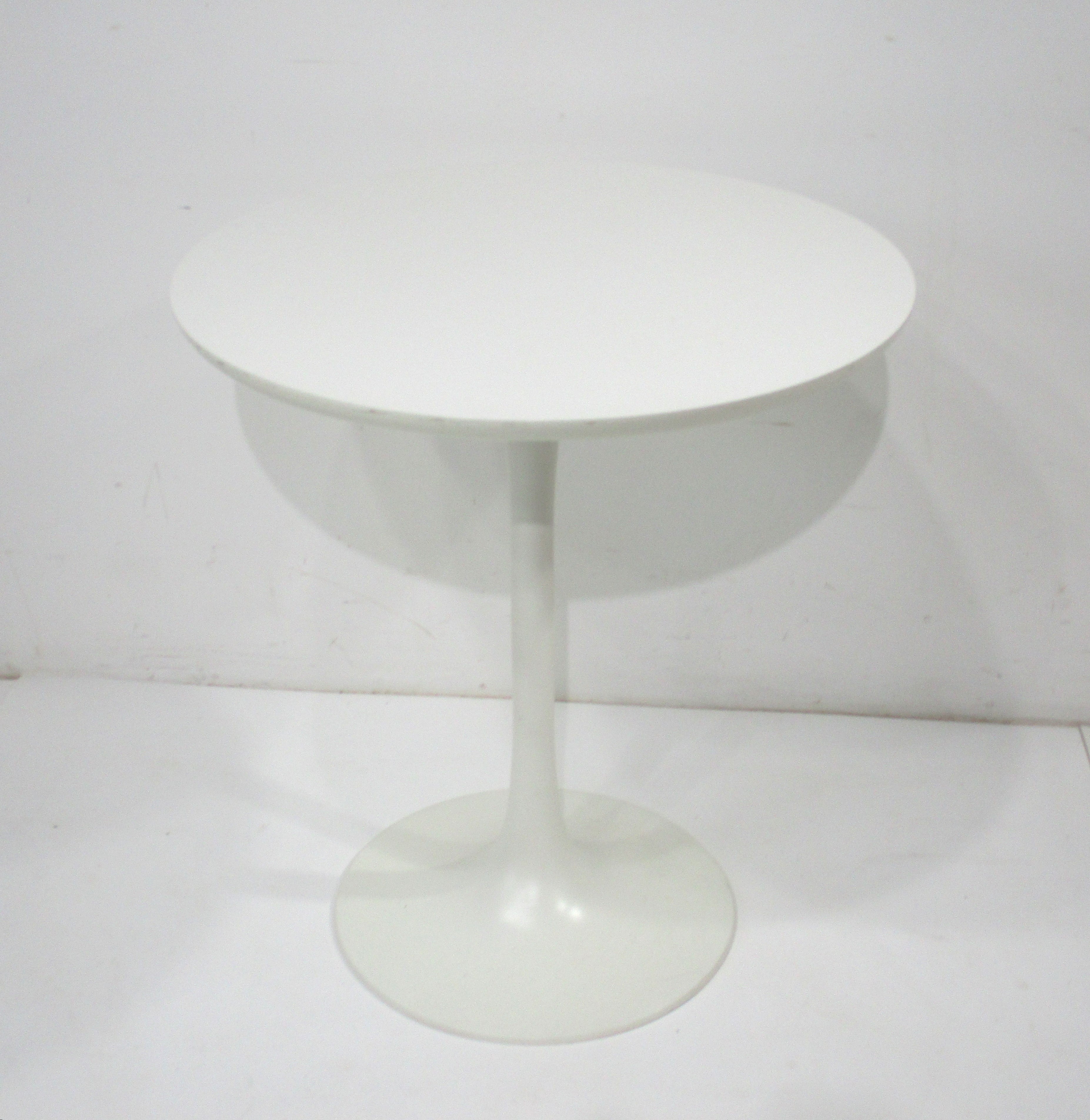 A taller round tulip side table or lamp table in white with matching Laminate top designed by Maurice Burke in the manner of Eero Saarinen and Knoll . Manufactured by the Burke furniture company making this style in larger , taller or bigger sizes