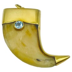 Retro Talon pendant featuring a predator's claw encased in an 18k yellow gold