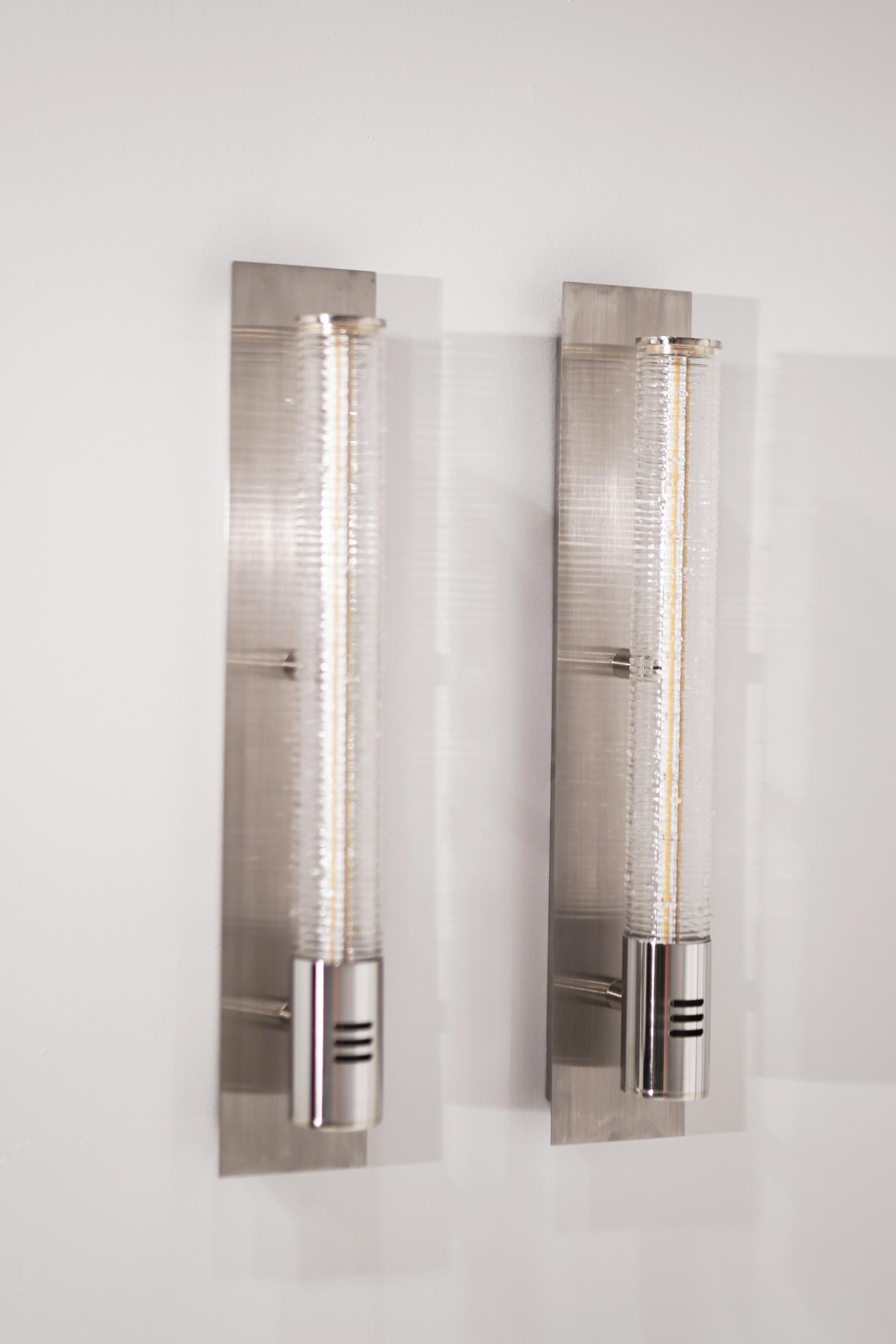 The Tamar Wand blown glass sconces come affixed to steel connectors at the bottom of the plate. The top of the wand is finished with a circular plate. The sleek features of this design allow for a variety of applications.

Hardware is available in