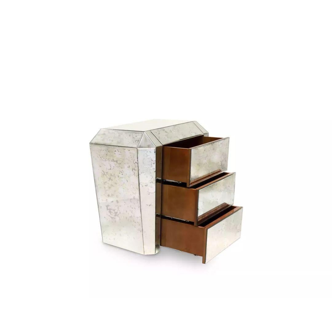 The provocatively vintage Tamara nightstand drips with enough Art Deco decadence to transport you back to the glamour of the Roaring Twenties. Her frame's strong geometric lines are coupled with luxurious and alluring mirror panels and three