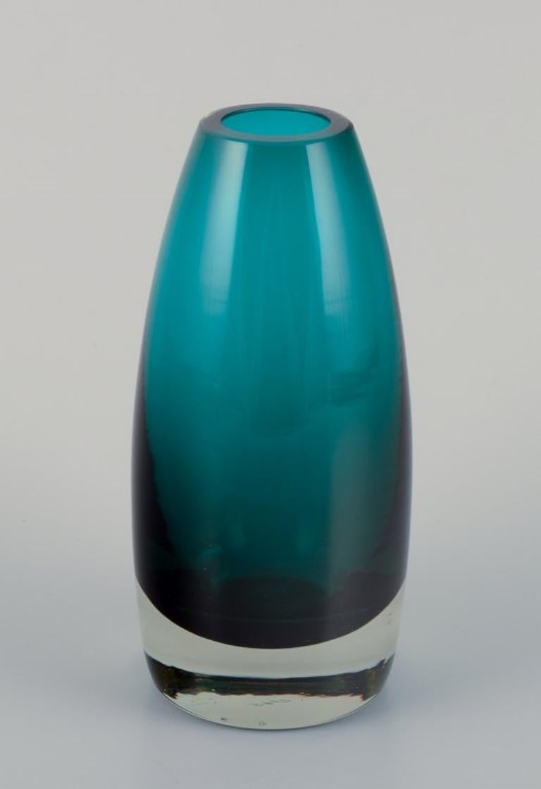 Tamara Aladin (1932-2019) for Riihimäen Lasi, Finland. 
Art glass vase in turquoise.
Model 1365.
1960s.
Marked.
Perfect condition.
Dimensions: H 16.0 cm x D 7.0 cm.