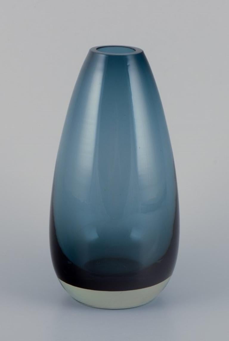 Tamara Aladin (1932-2019) for Riihimäen Lasi, Finland. 
Art glass vase in turquoise.
Model 1365.
1960s.
Marked.
Perfect condition.
Dimensions: H 16.0 cm x D 7.0 cm.
