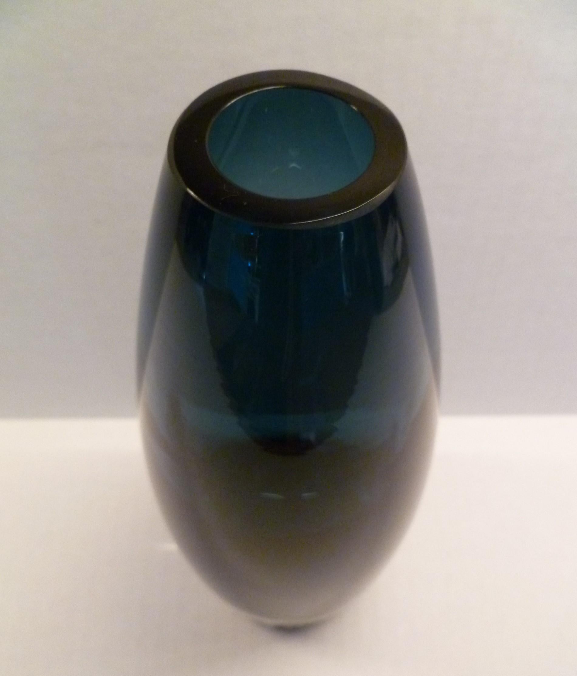 Tamara Aladin, b.1932, designed this vase early in her tenure with Riihimäki Glass Factory of Finland. Riihimäen Lasi Oy became well known for its modern colorful and innovative Space Age shapes created by designers like Aladin. This listing is for