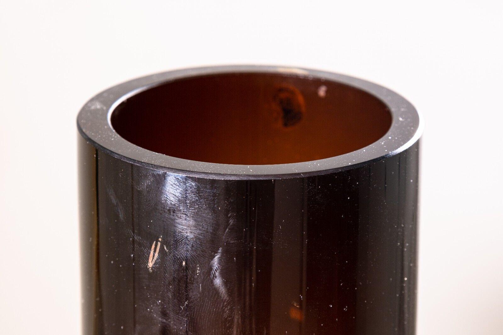A Tamara Aladin for Riihimaki Lasi Finnish brown glass vessel. A stunning piece of mid century modern art glass with Finnish origins. This piece features a radiant brown coloring, and a ribbed cylinder design. It is in very good condition and