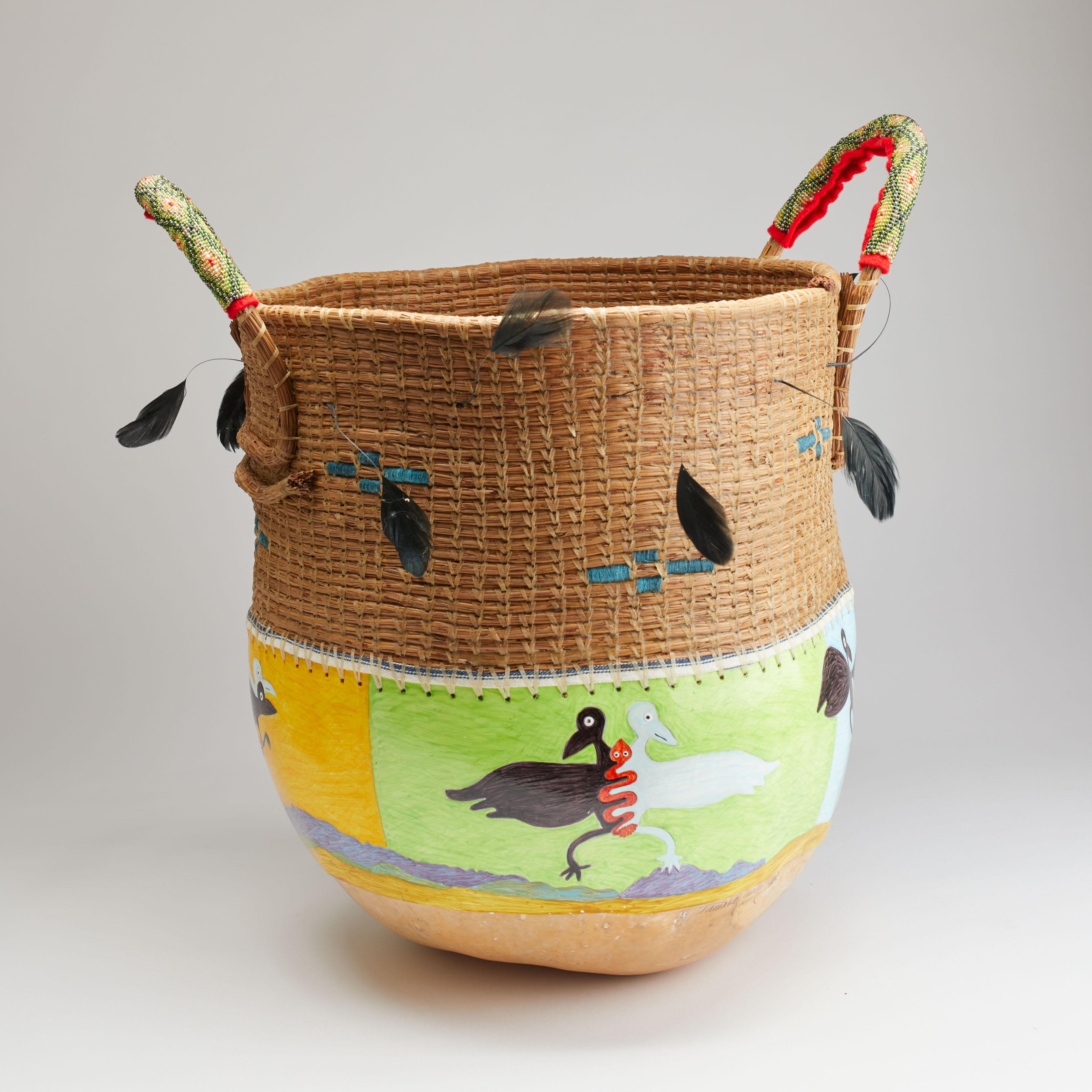 Gourd pot sculpture made of traditional materials of pine needles with beeswax sealant, gourd lined with pine sap, oil paint on applied primed canvas, cotton cloth, feathers, loom beading.