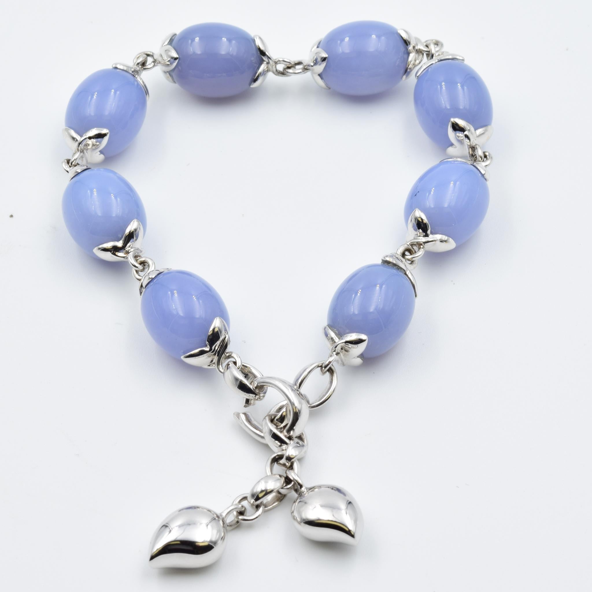 The COCONUT bracelet features eight natural, olive-shaped beads of shimmering blue chalcedony. This timelessly elegant bracelet is easy to wear and fits any wrist size.  This is a glamorous design which can be worn casually or to a fancy night out.