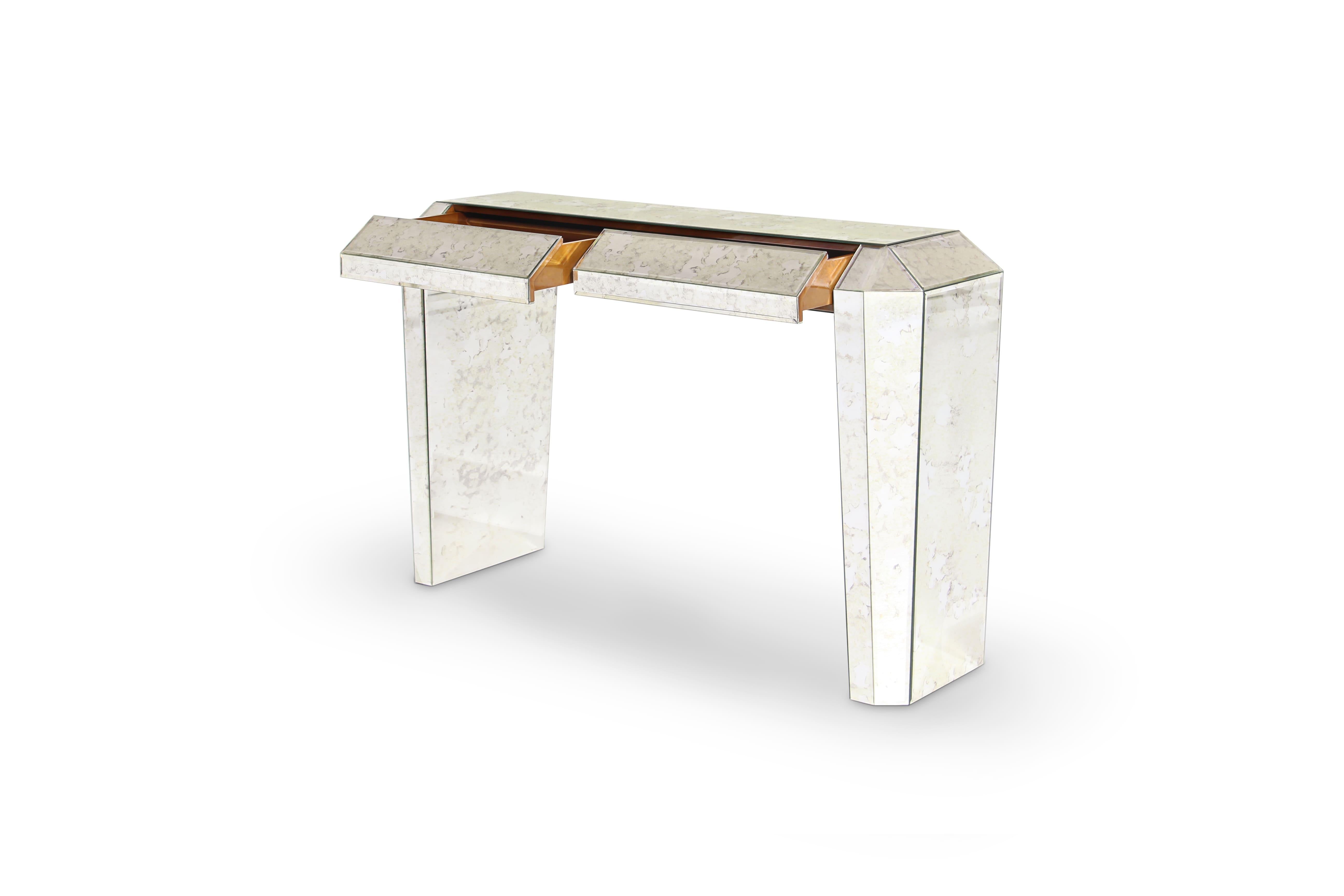 The provocatively vintage Tamara console drips with enough Art Deco decadence to transport you back to the glamour of the Roaring Twenties. Her frame's strong geometric lines are coupled with luxurious and alluring mirror panels and two