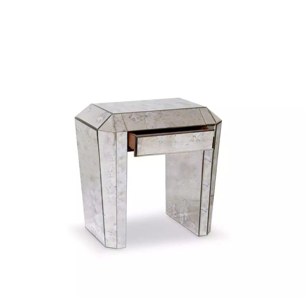 The provocatively vintage Tamara nightstand drips with enough Art Deco decadence to transport you back to the glamour of the Roaring Twenties. Her frame's strong geometric lines are coupled with luxurious and alluring mirror panels and one