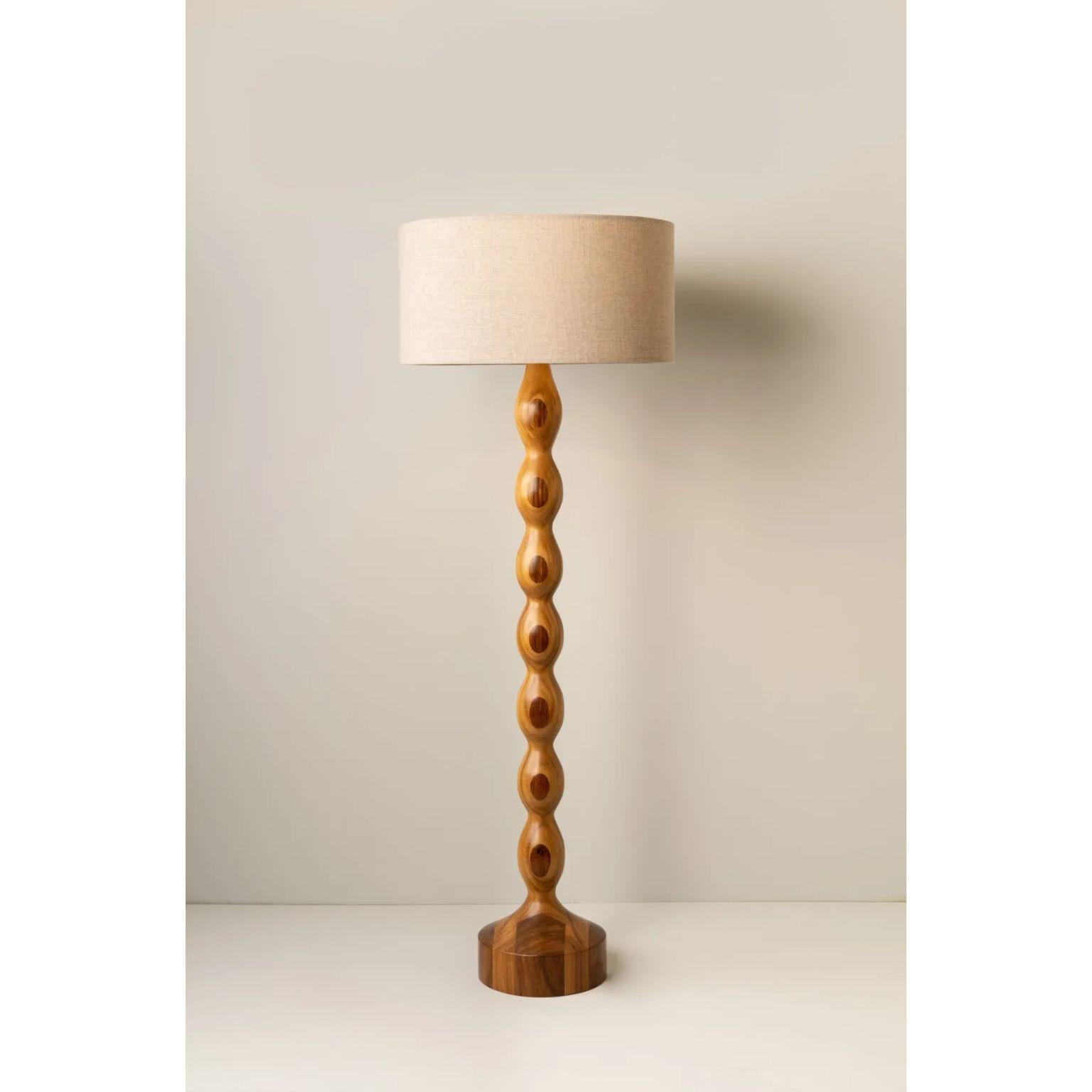 Tamarindo Floor Lamp by Isabel Moncada
Dimensions: Ø 60 x H 170 cm.
Materials: Turned parota wood, fiberglass and linen.

Its symmetrical undulated base is timeless with proportions and finishes that turn Tamarindo into an eclectic yet contemporary