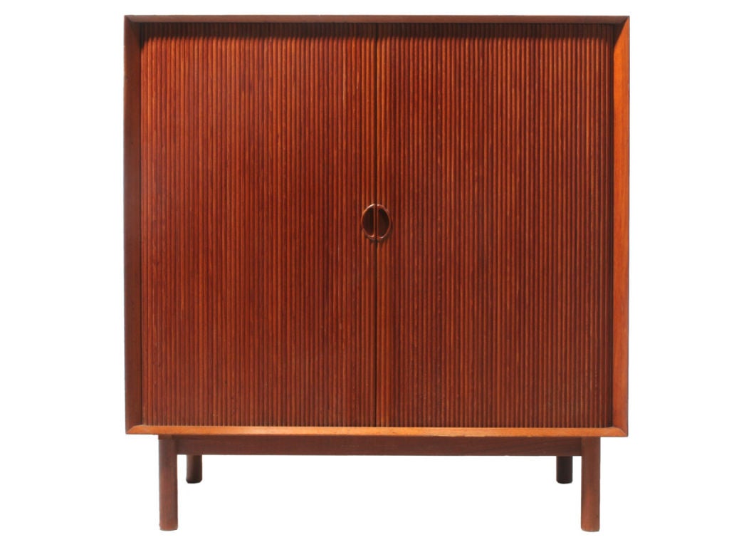 A Scandinavian Modern modular cabinet by Peter Hvidt & Orla Mølgaard-Nielsen. Made from solid Burmese teak with tambour doors, cabinet features beveled edge and finger jointed details. Produced in Denmark circa 1950s. 
Modular design, removable