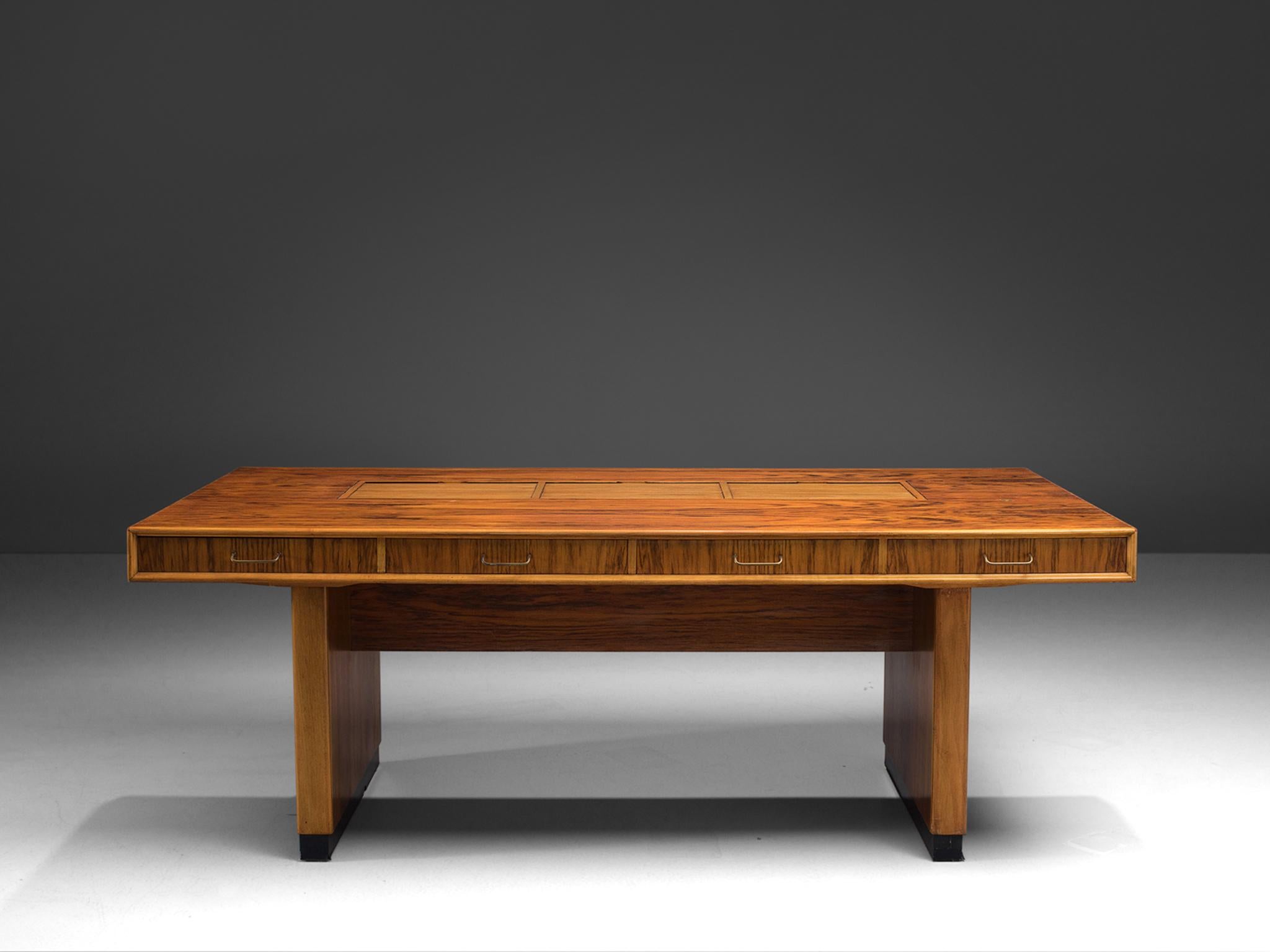 Desk, rosewood and walnut, the Netherlands, 1960s.

This classic, architectural piece is executed with three storage spaces on the top of the desk and on both sides. The piece stands out thanks to the use of various types of wood such as walnut and