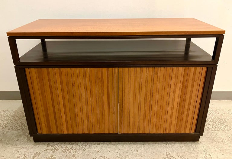 A chic and versatile cabinet with blond tamowood top and burnt almond walnut tambour doors on a dark mahogany case. Nice details like the razor-thin brass door pulls, and dappled variegation to wood. The raised superstructure makes this a perfect