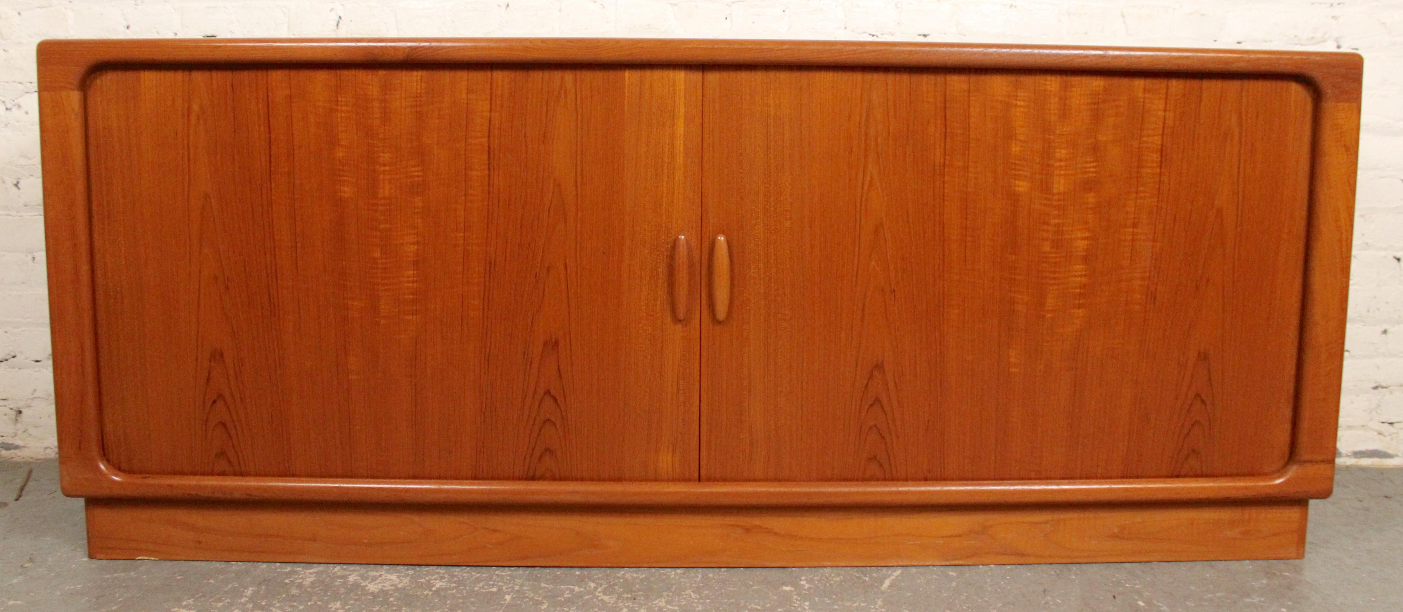 Lange Kredenz aus der Mitte des Jahrhunderts, hergestellt von Dyrlund aus Dänemark in den 1960er Jahren. Mit Rolltüren, die sich hinter dem Schrank zurückziehen und sowohl offenen Stauraum als auch fünf Schubladen freigeben. Meisterhaft gefertigt