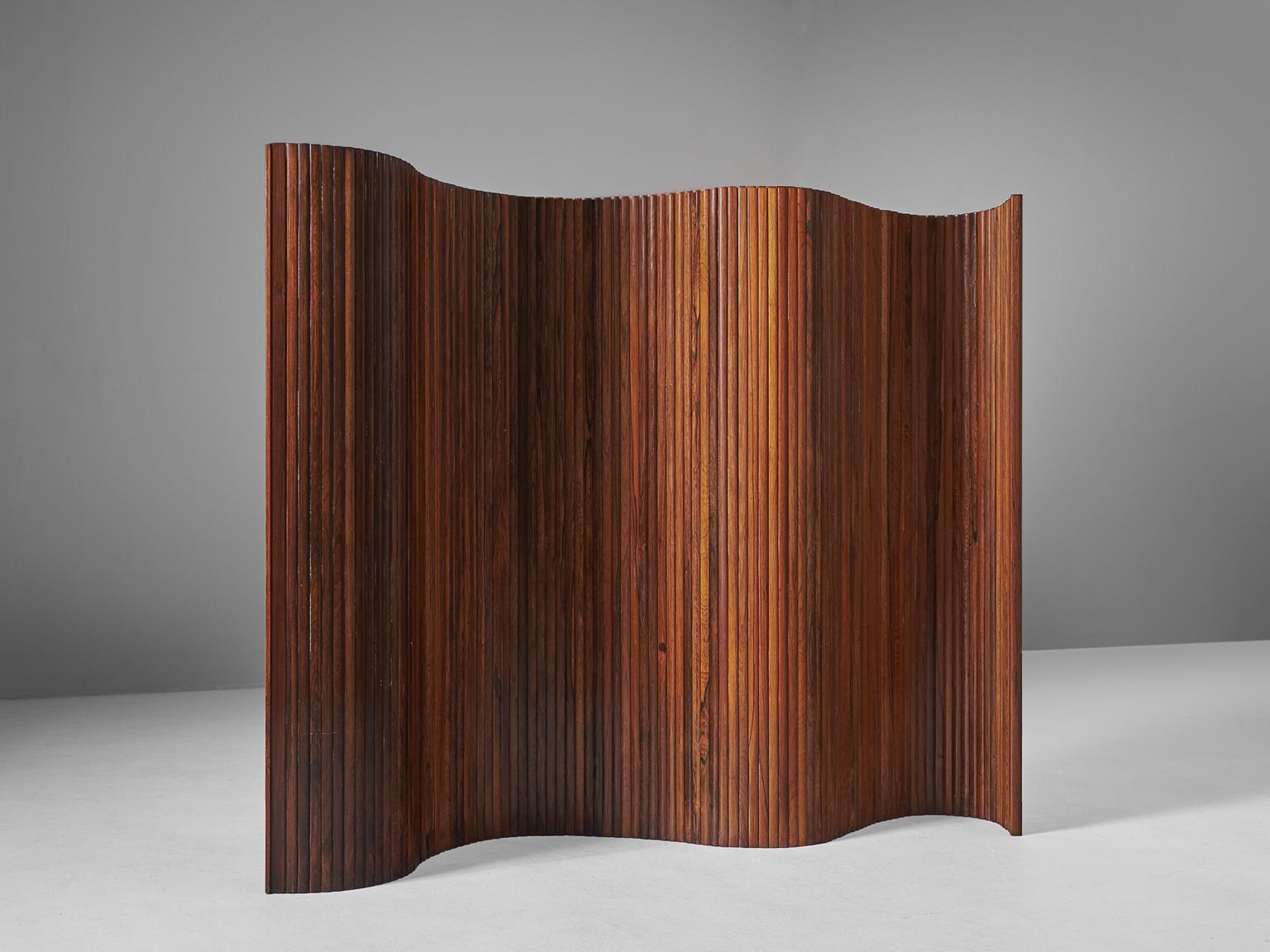 Beautifully shaped roll-able and versatile room divider made of vertically narrow solid rosewood slets. This tambour 'wave' formed screen could easily fit in every interior. Can be shaped in numerous ways and is in perfect condition.

In style