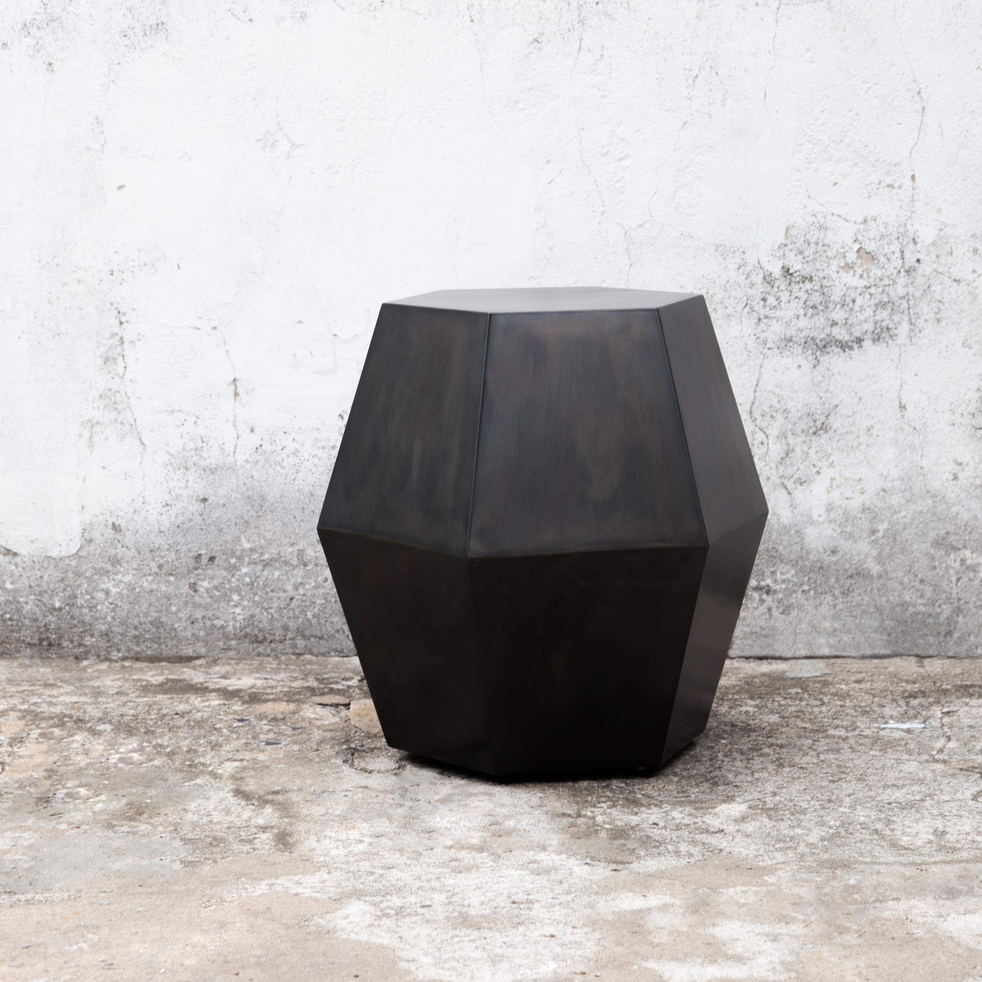 The name of the Tamino Hex comes from its hexagonal shape and can be specified in any of Costantini’s available materials and finishes. Shown here in burnished steel, these side tables feature a modern, geometric shape that allows the subtle