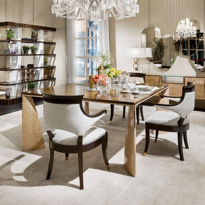 A splendid design that showcases a bold profile distinguished by uniquely-shaped legs made of Tamo wood, this dining table will take center stage in modern interiors. Enriched with polished brass lining, the legs support a precious Siena marble top,